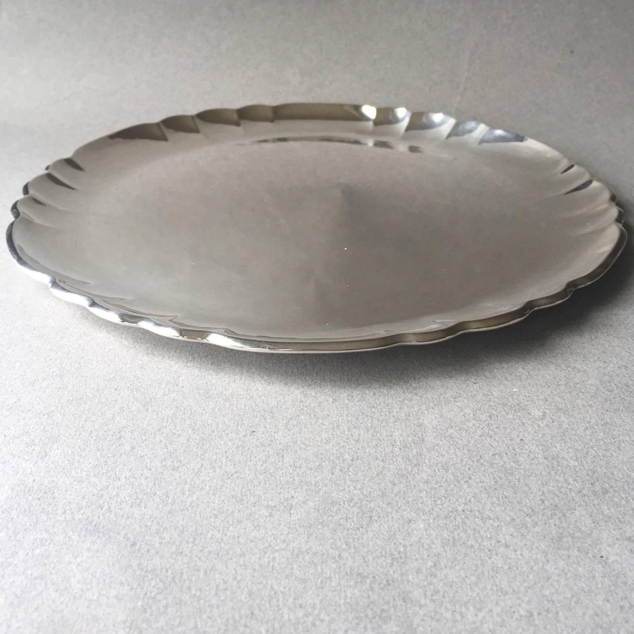 Georg Jensen sterling silver tray no. 519C.

This is a fine example of Georg Jensen craftsmanship, circa 1925-1932. This hand-hammered tray is circular with scalloped edges.

Measures: 10.75