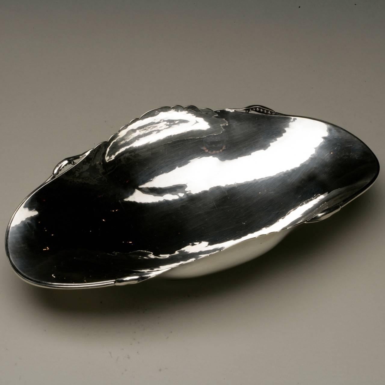 Peer Smed sterling silver dish.

Beautiful hand-wrought hand-raised sterling silver footed dish in a gondola shape with berry details. Perfect for serving peas or tea biscuits. 

Peer Smed's works are very rare to find and entirely made by his
