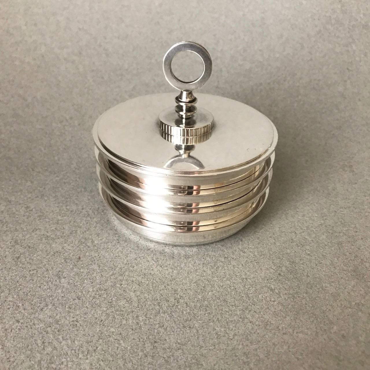Georg Jensen sterling silver coaster set, no. 817.

Set of four stacking coasters with lid, designed by Sigvard Bernadotte. Very heavy, excellent condition. Measures 3" x 3"

Perfect for use as individual nut, condiment or olive