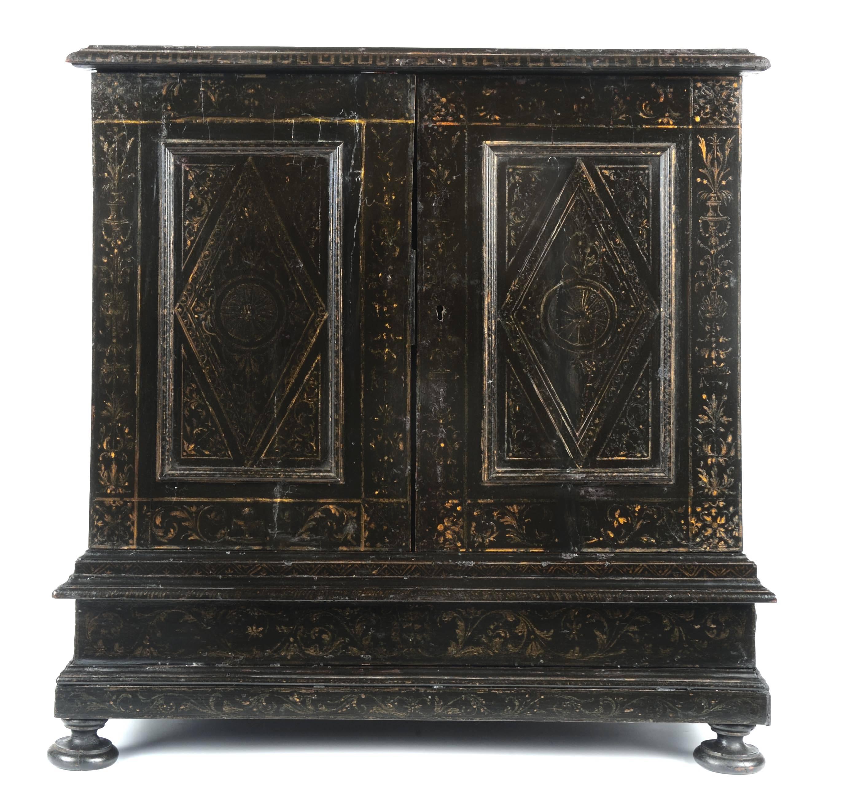 An Italian ormolu-mounted, ebonized wood and Pietra Dura table cabinet (or collector’s cabinet) with elaborate gilt foliate stenciling and grisaille grotesques. The decoration imitates classical architecture with drawers around a central portico and