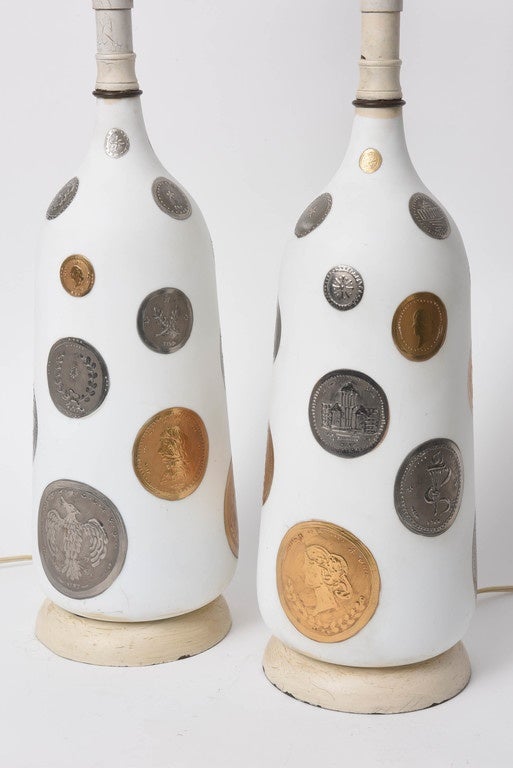 This witty pair of lamps are decorated with hand-painted gold and silver coins on hand-blown white opaque glass.  From the 1960s.