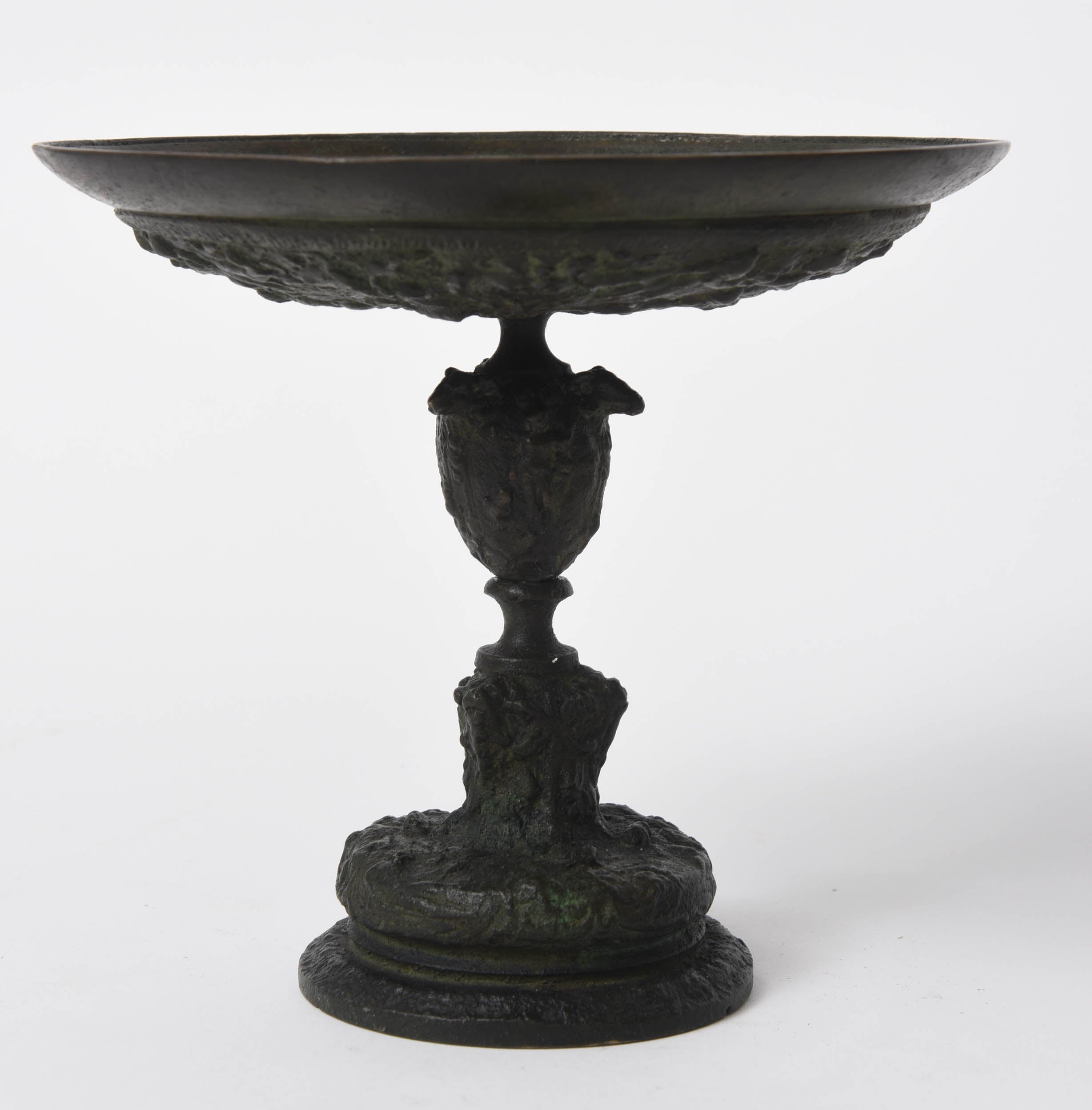 This highly decorative patinated bronze tazza in 16th century Italian style is covered above and below with low relief figures depicting tritons, mermaids and mermen battling at sea.   The stem of the tazza is decorated with a continuous frieze of