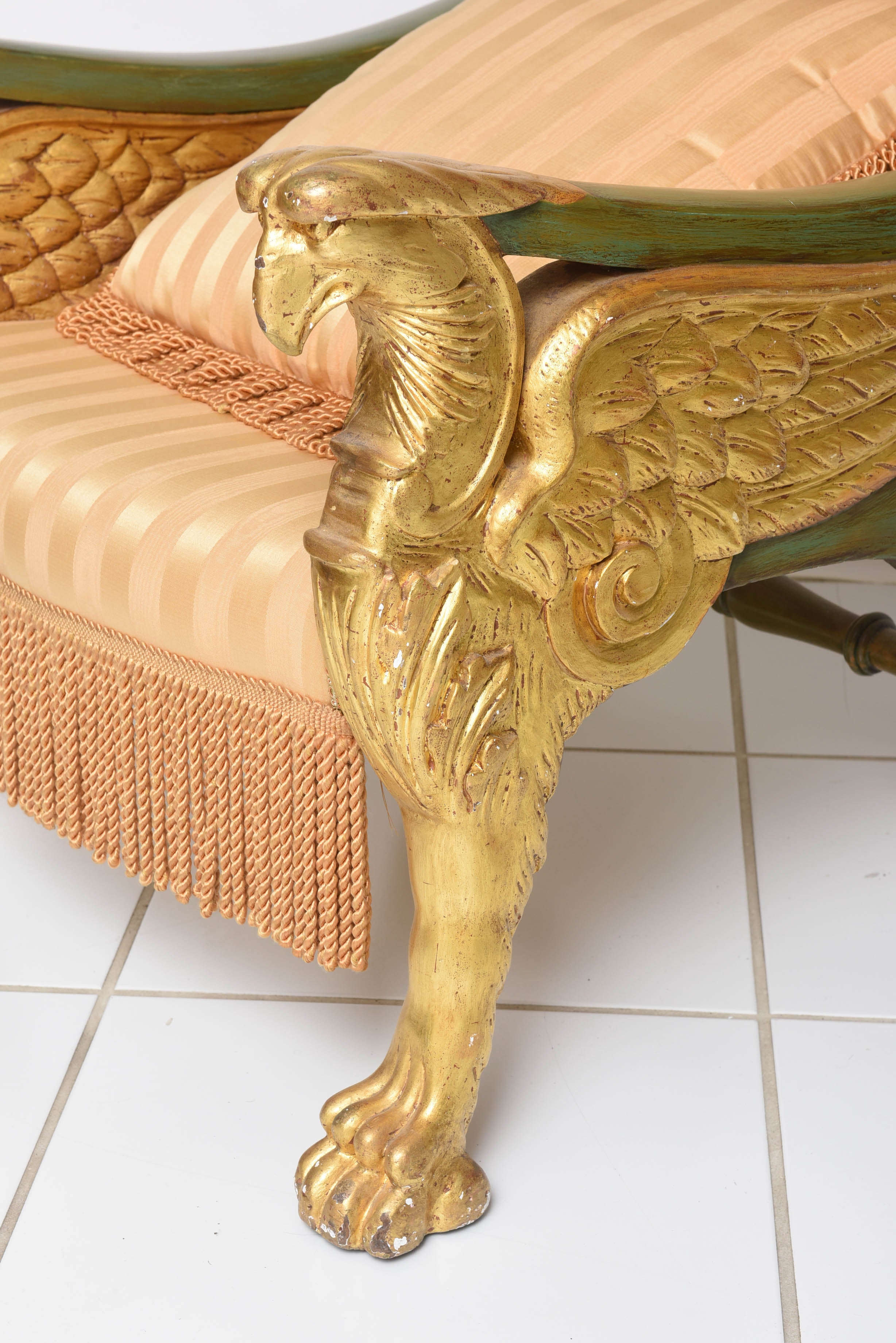 Charles Heathcote Tatham (1772-1842) was an English architect who designed and supplied furniture during the regency period.

This extraordinary carved giltwood throne chair is upholstered in silk and has winged griffon sides and feet.  The back
