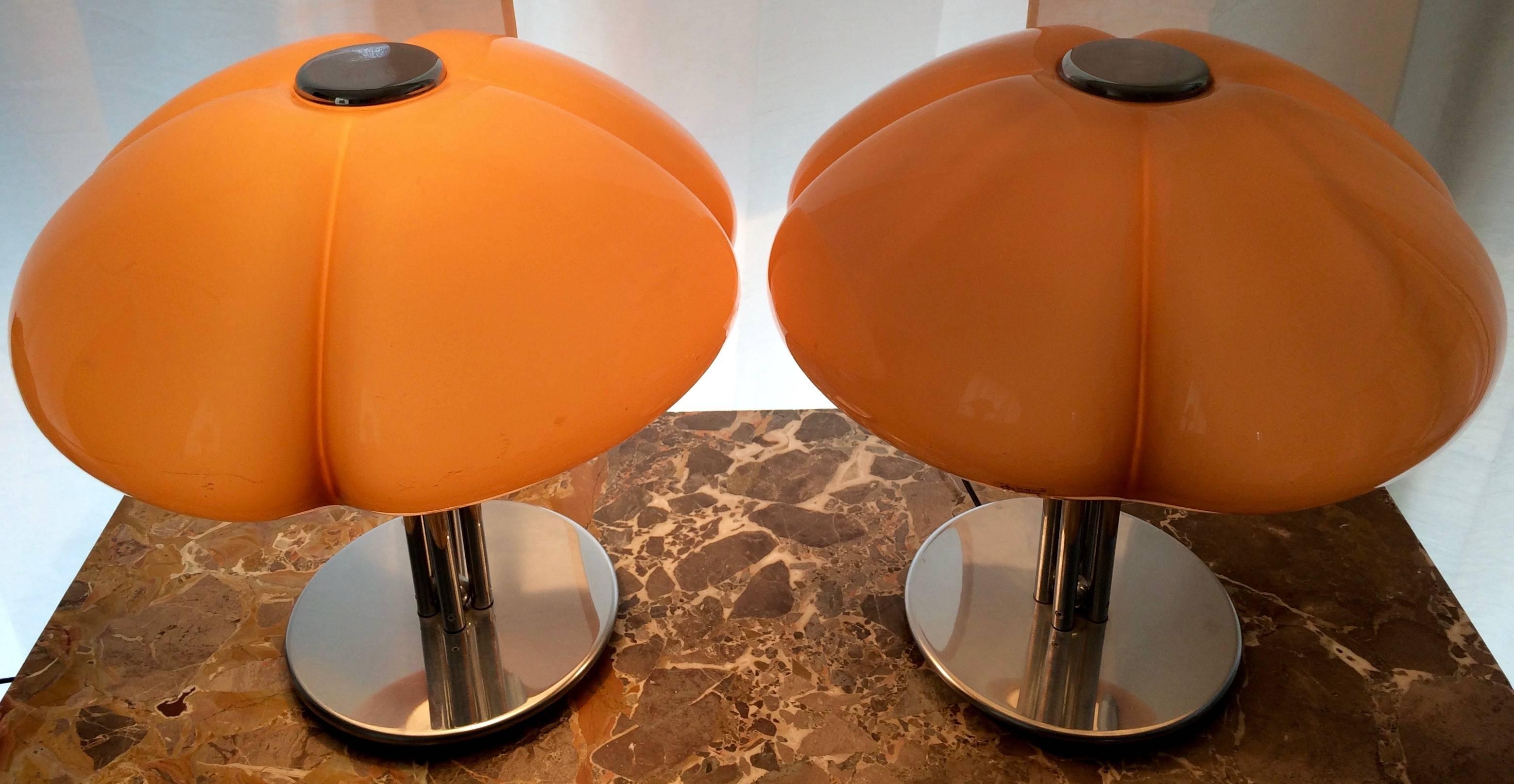 Pair of mid-1970s Italian Harvey Guzzini "Quadrifoglio" or "4-Leaf Clover' Table Lamps

Design by Gae Aulenti.

A caramel colored plastic shade over a chromed metal base.

Both Lamps are in good working condition