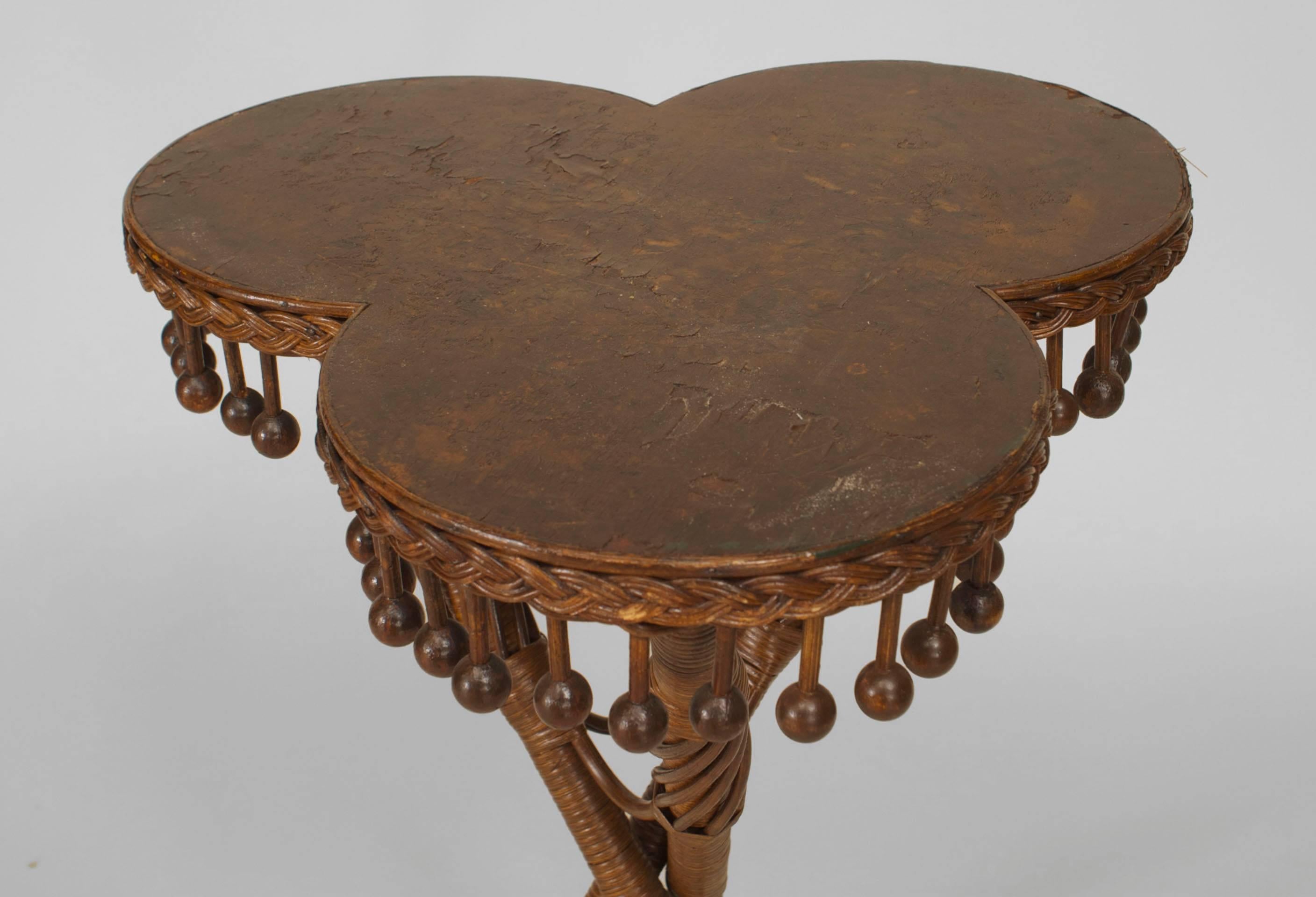 American Victorian natural wicker tripod table with tri-lobed top and suspended ball and stick apron (Whitney Reed Chair Co.).
 