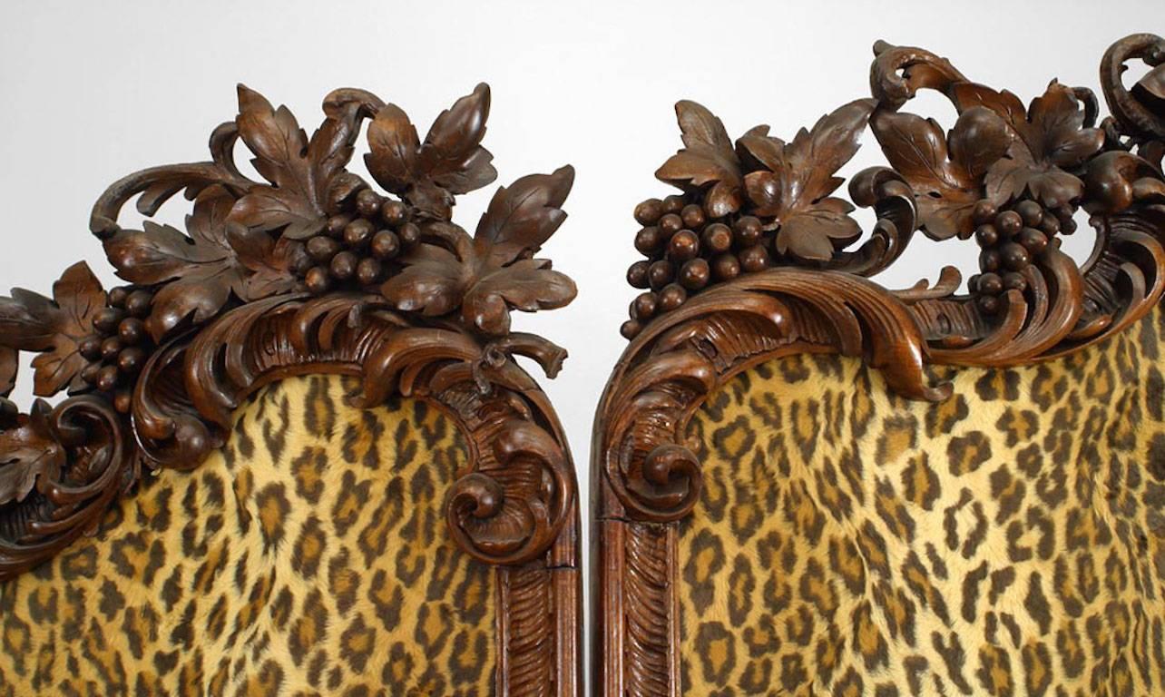 Rustic Black Forest (19th Century) walnut floral carved 4 fold screen with leopard style fabric upholstered panels.
