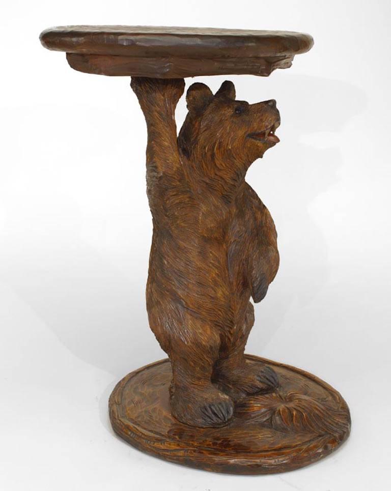 Rustic Black Forest-style (20th Century) walnut end table with figure of bear standing on carved floral design base and holding oval chip carved top.

