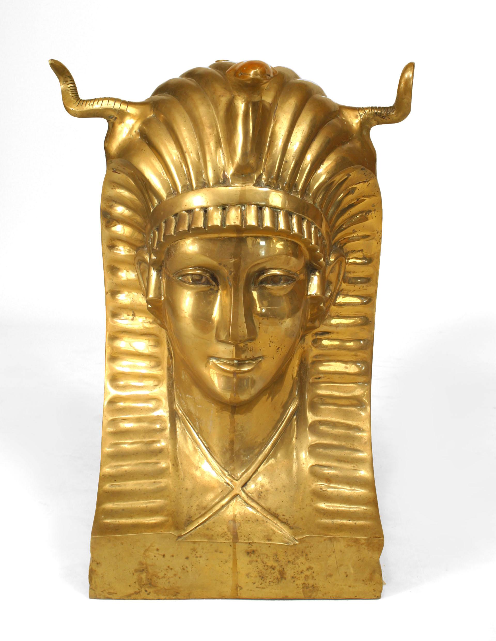 Midcentury American (1970s) dining table having a rectangular glass top supported by a pair of large bronze busts of a Pharaoh wearing a headdress.
