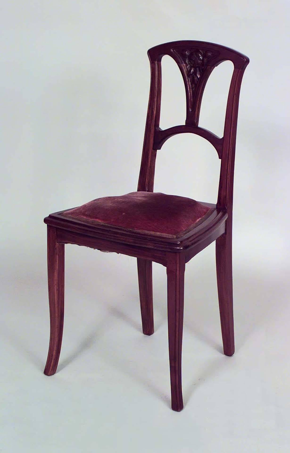 French Art Nouveau walnut open back side chair with carved floral design and pink velvet seat.
