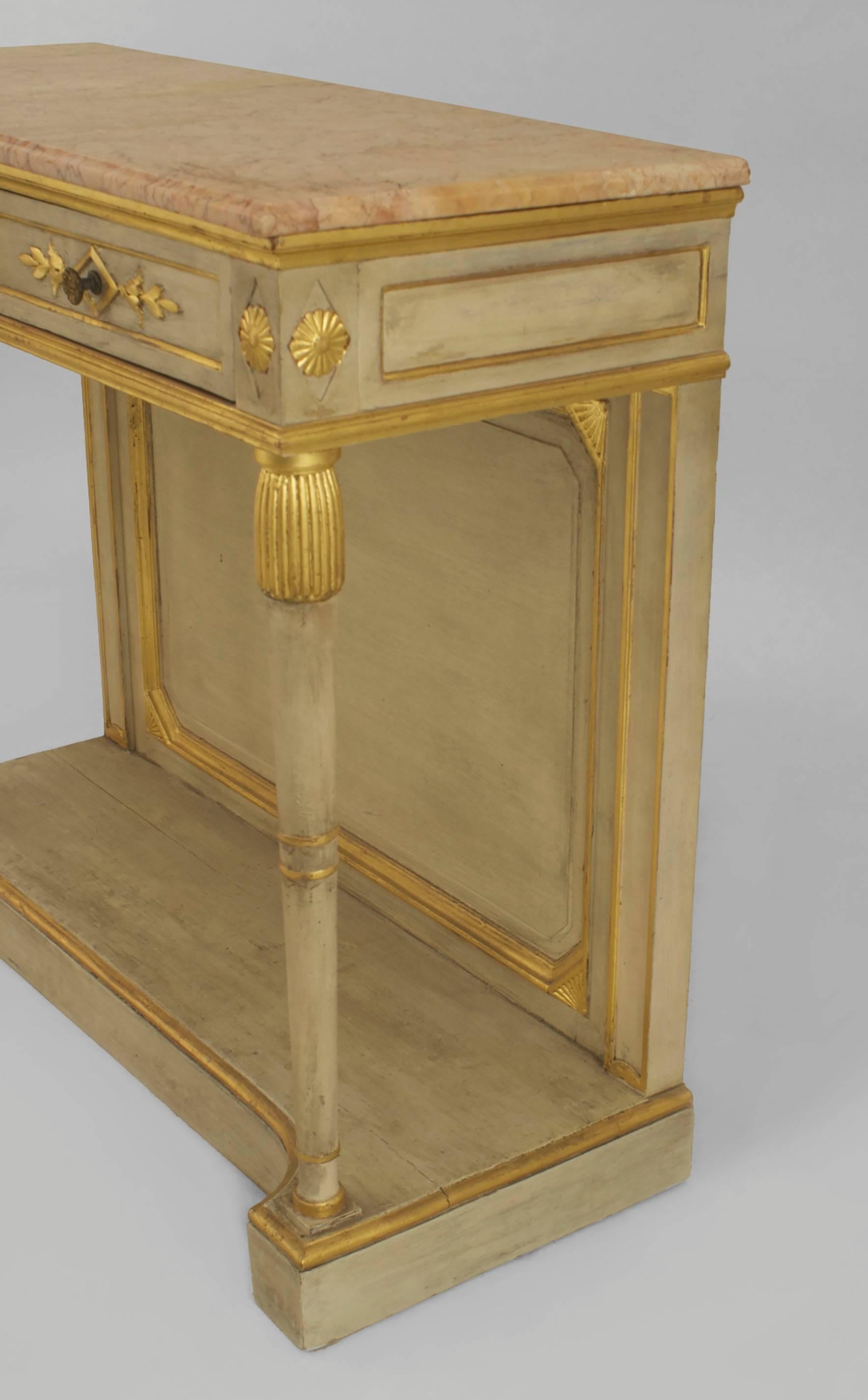 Pair of neoclassic style (1940s) off-white painted and gilt carved
trimmed console tables with a platform base and two drawers under a marble top (stamped: JANSEN).