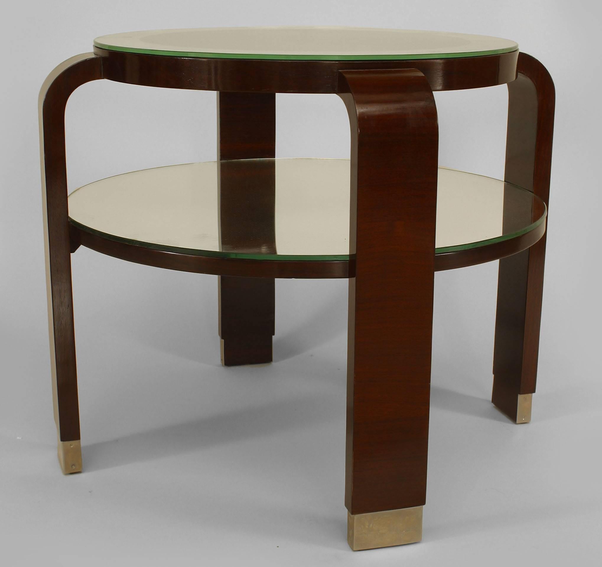 French Art Deco palisander low end table with four rectangular legs and a round
glass top with a mirrored border and mirrored shelf with nickel-plated sabots (attributed: Dominique).