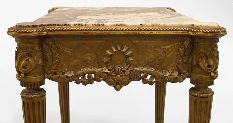 French Louis XVI-style (19th Century) gilt rectangular end table with open cane stretcher and rouge marble top.
