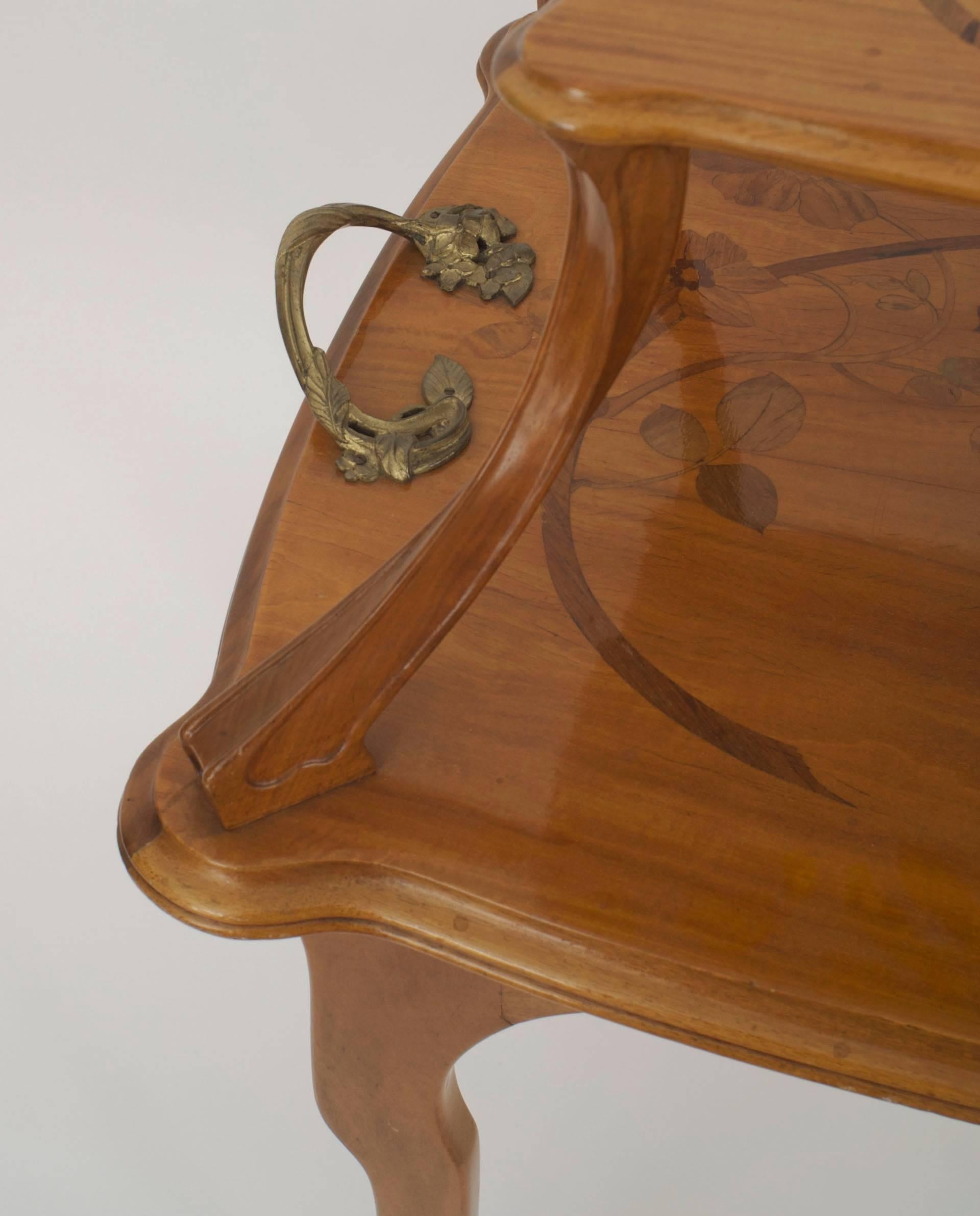 French Art Nouveau walnut rectangular two-tier table with floral inlaid design and bronze floral design side handles (signed MAJORELLE).
