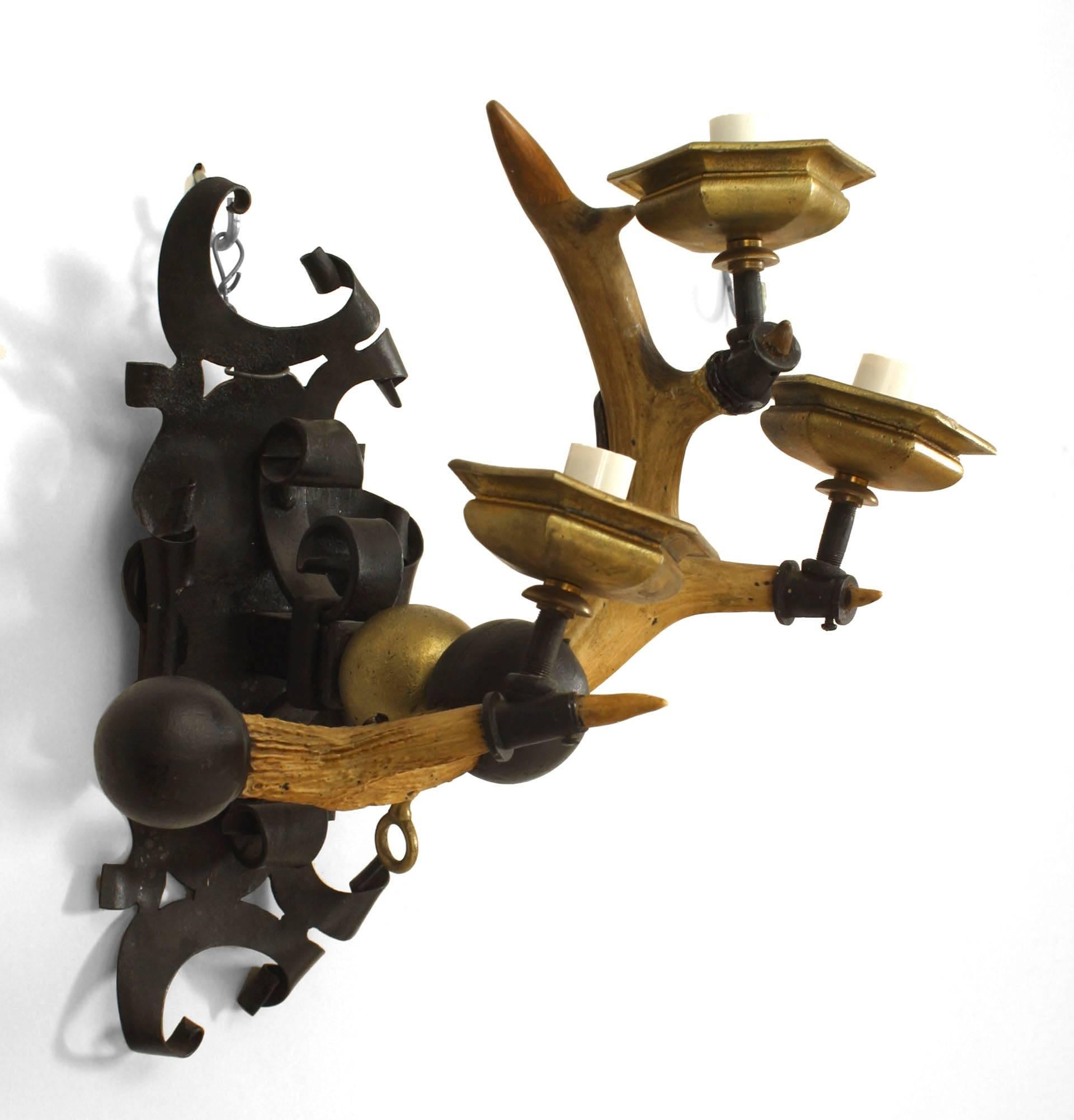 Pair of similar Rustic (19th Century) horn and wrought iron wall sconces with brass bobeches and three and four arms each. (PRICED AS Pair)
