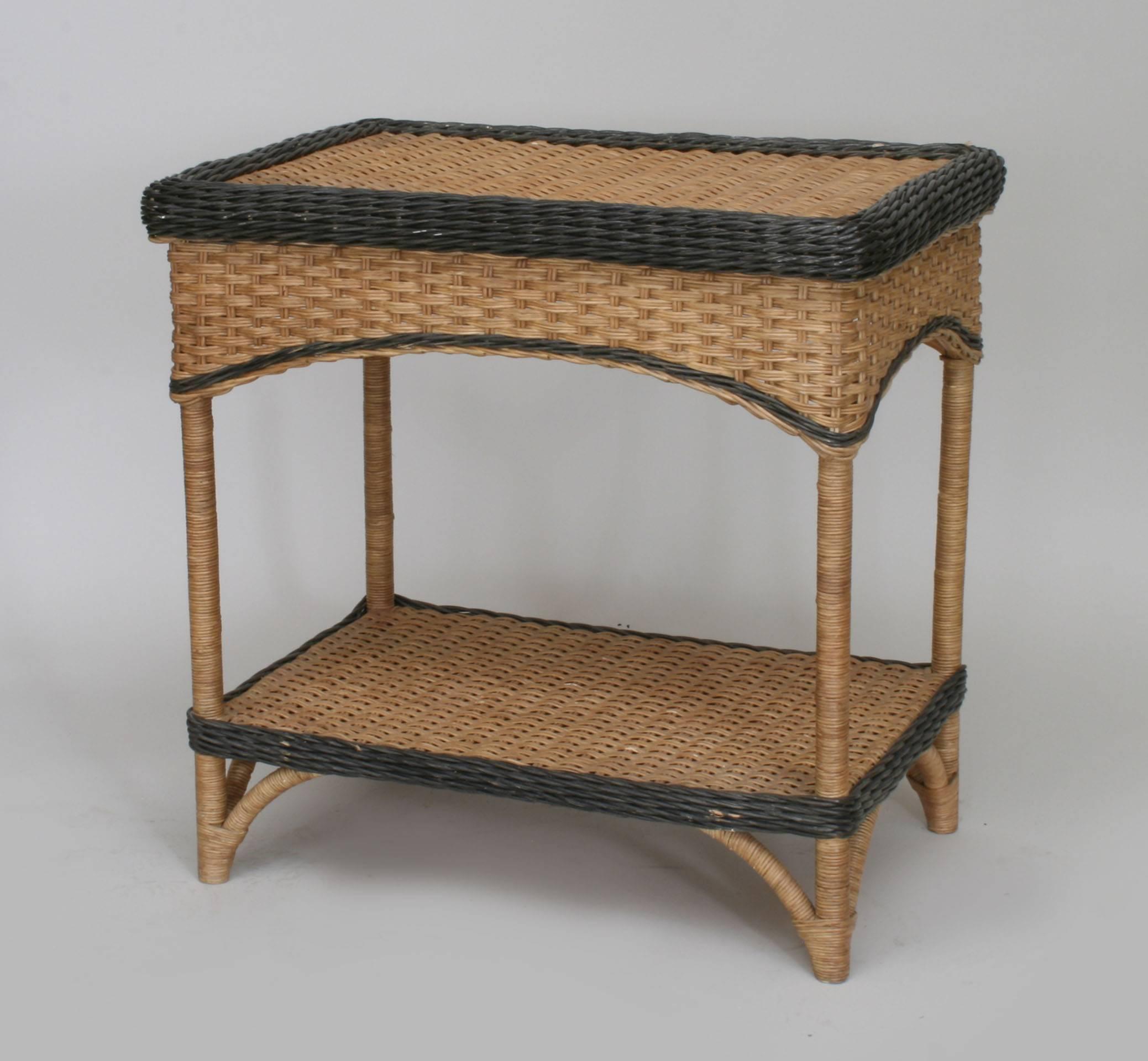 French, 1940s natural wicker rectangular end table with shelf and black painted border and trim and woven arch design apron.
  