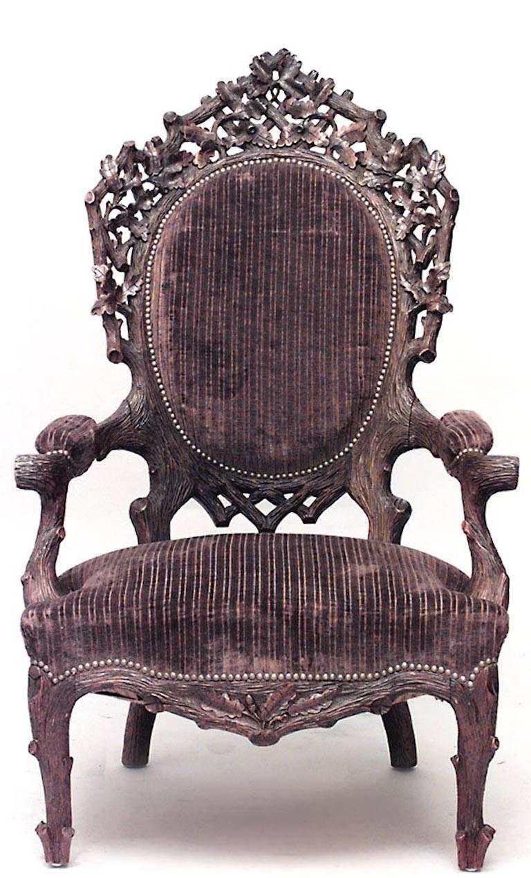 Rustic Black Forest (19th Cent) walnut large open arm chair with carved leaf design filigree top and brown velvet upholstered seat and back with nailhead trim (seat: 16¬æ