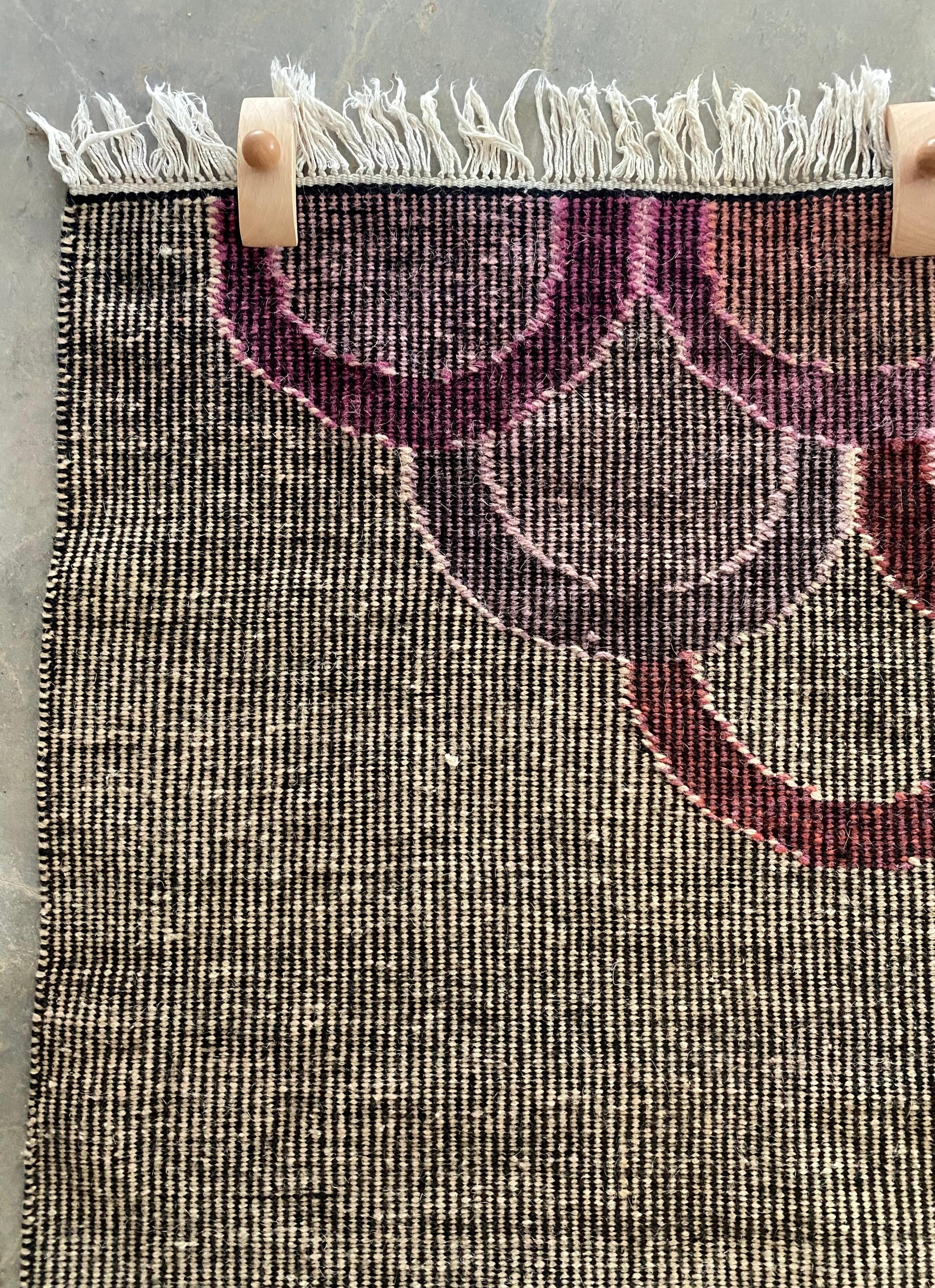 Fabulous Japanese-inspired handwoven wool tapestry, signed “BN” at the lower right. This bold textile blends graphic, hard-edge precision with painterly color, featuring a muted, woven, ivory and black field punctuated by lavender, merlot, peach,