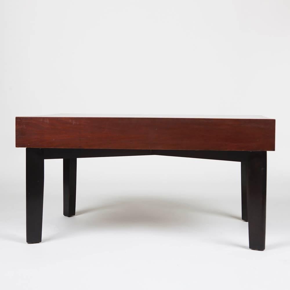 A Mid-Century Modern Classic George Nelson coffee table in walnut with ebonized legs and a pull-out, removable tray on each end, circa 1954. Nelson's brilliantly functional design allows the trays to be removed for serving or flipped to extend the