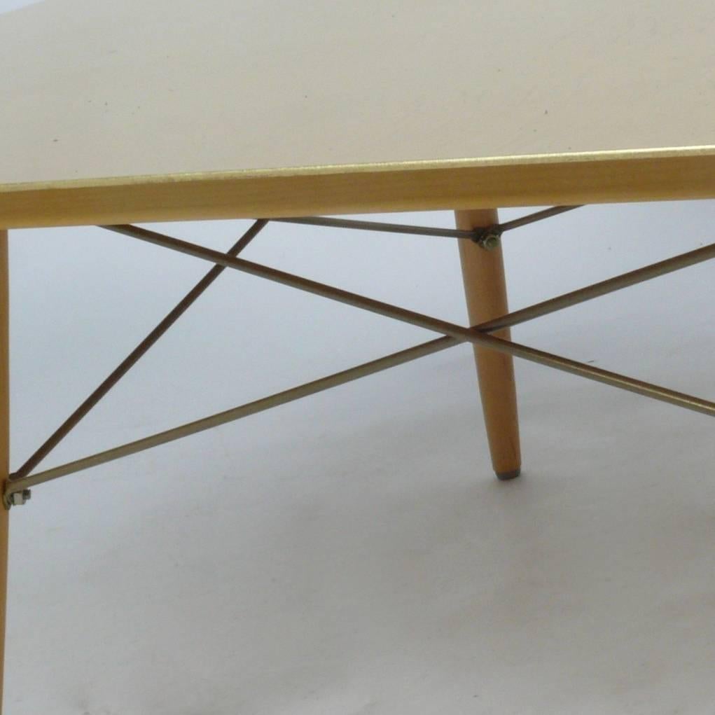 Striking coffee table in a lacquered gold leaf, solid brass top over a birch and enameled steel base, signed with brass plate and paper label numbering it 299 of an edition of 500. A very limited 1999 production by Herman Miller produced to