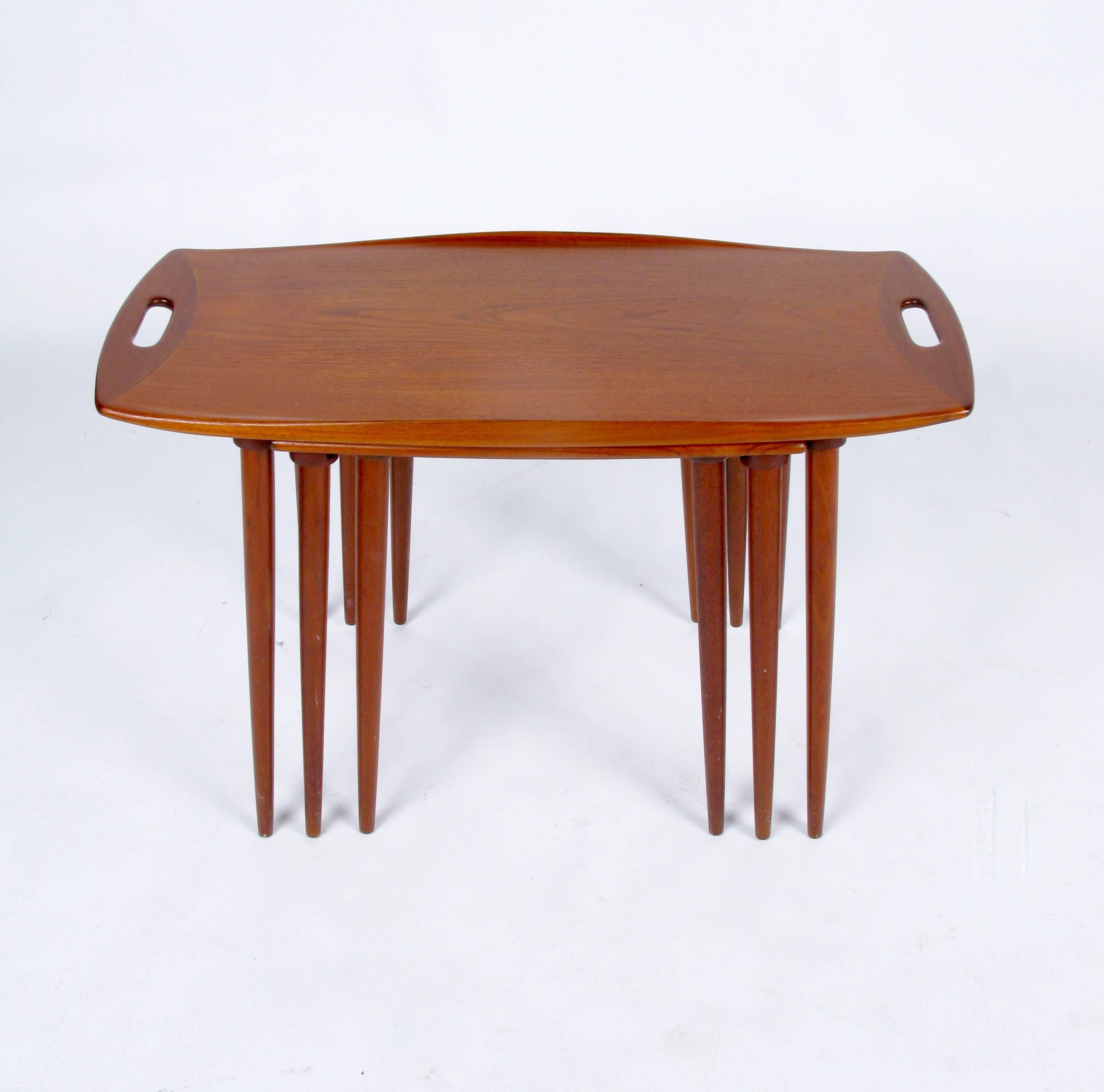 1950s set of three nest tables in oiled teak by Jens Quistgaard for Nissen, Denmark. The two larger tables each have a track for the lower table to slide into. Excellent restored condition.
