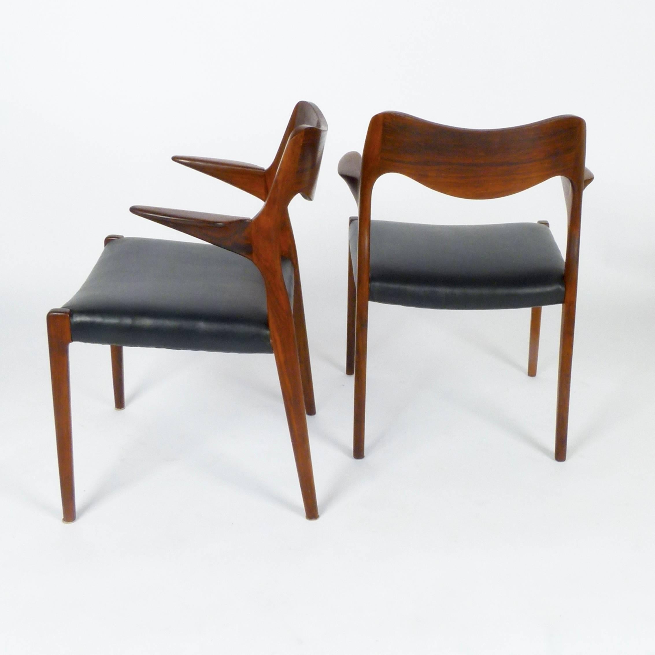Collection of four model 55 armchairs in rosewood by Niels Møller, Denmark. Sold separately. New leatherette upholstery.