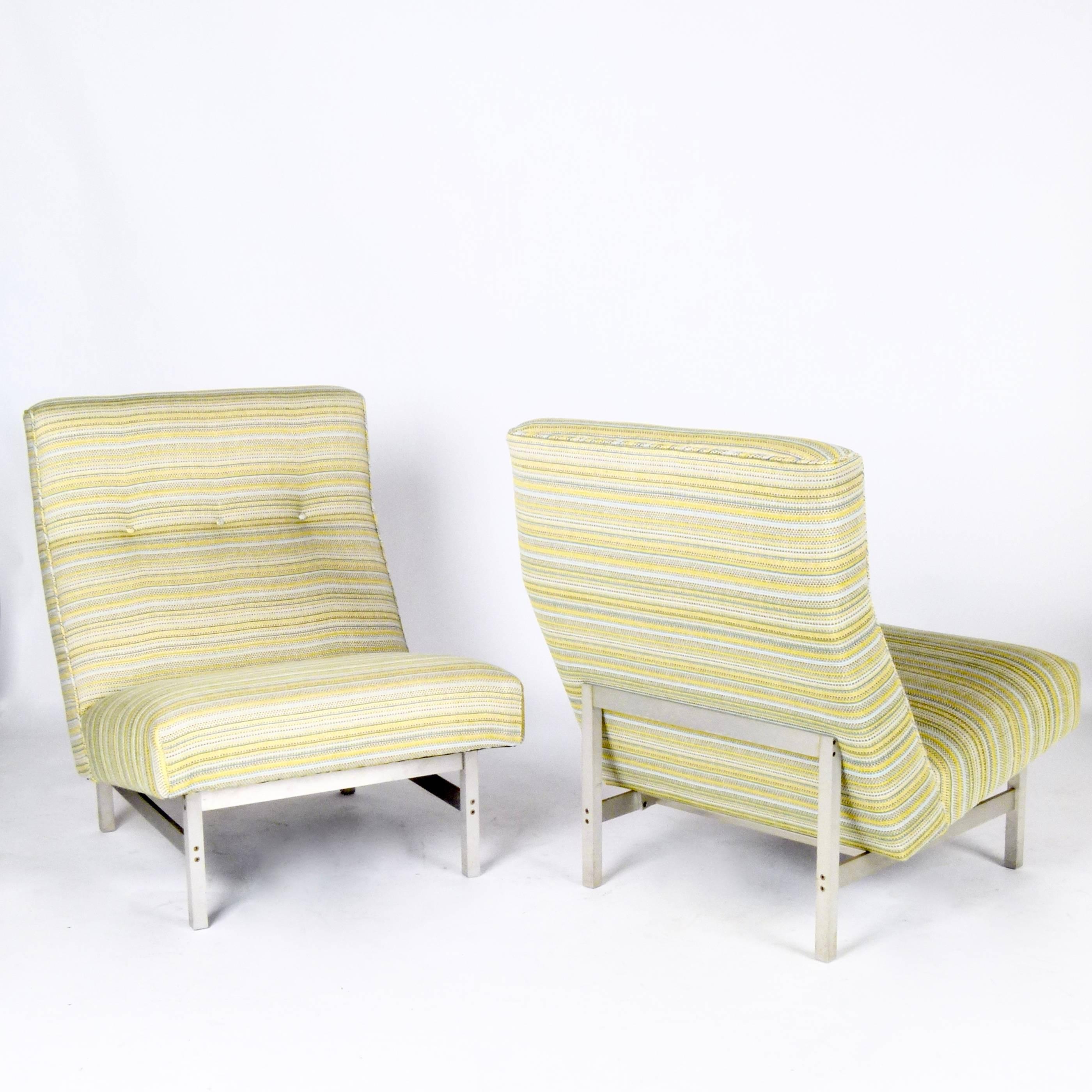 Pair of slipper-style lounge chairs designed by Florence Knoll for Knoll Associates with solid brushed steel base and new upholstery, circa 1958.