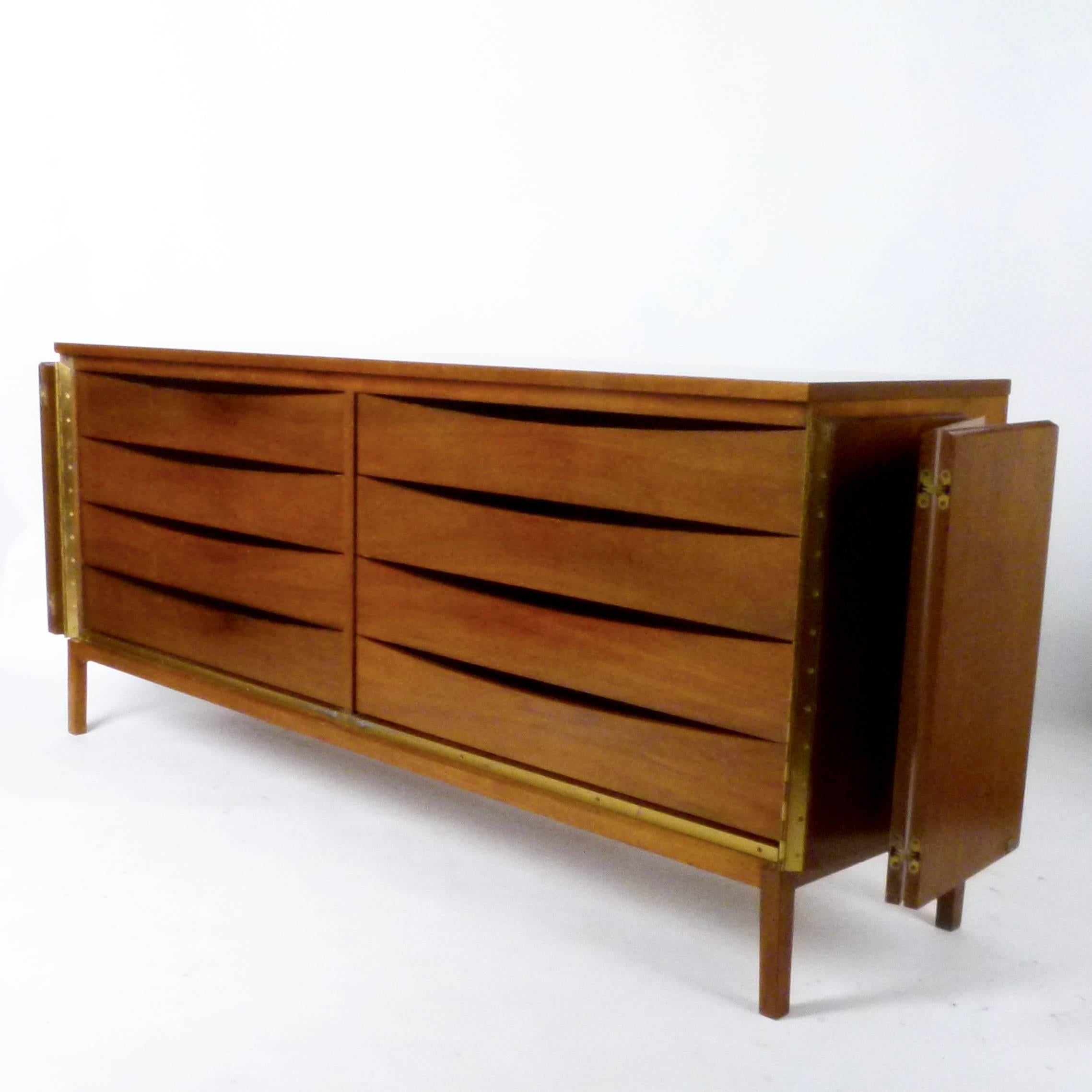 Walnut dresser with eight drawers behind two tri-fold doors by Paul McCobb from his Irwin collection for Calvin, circa 1960.