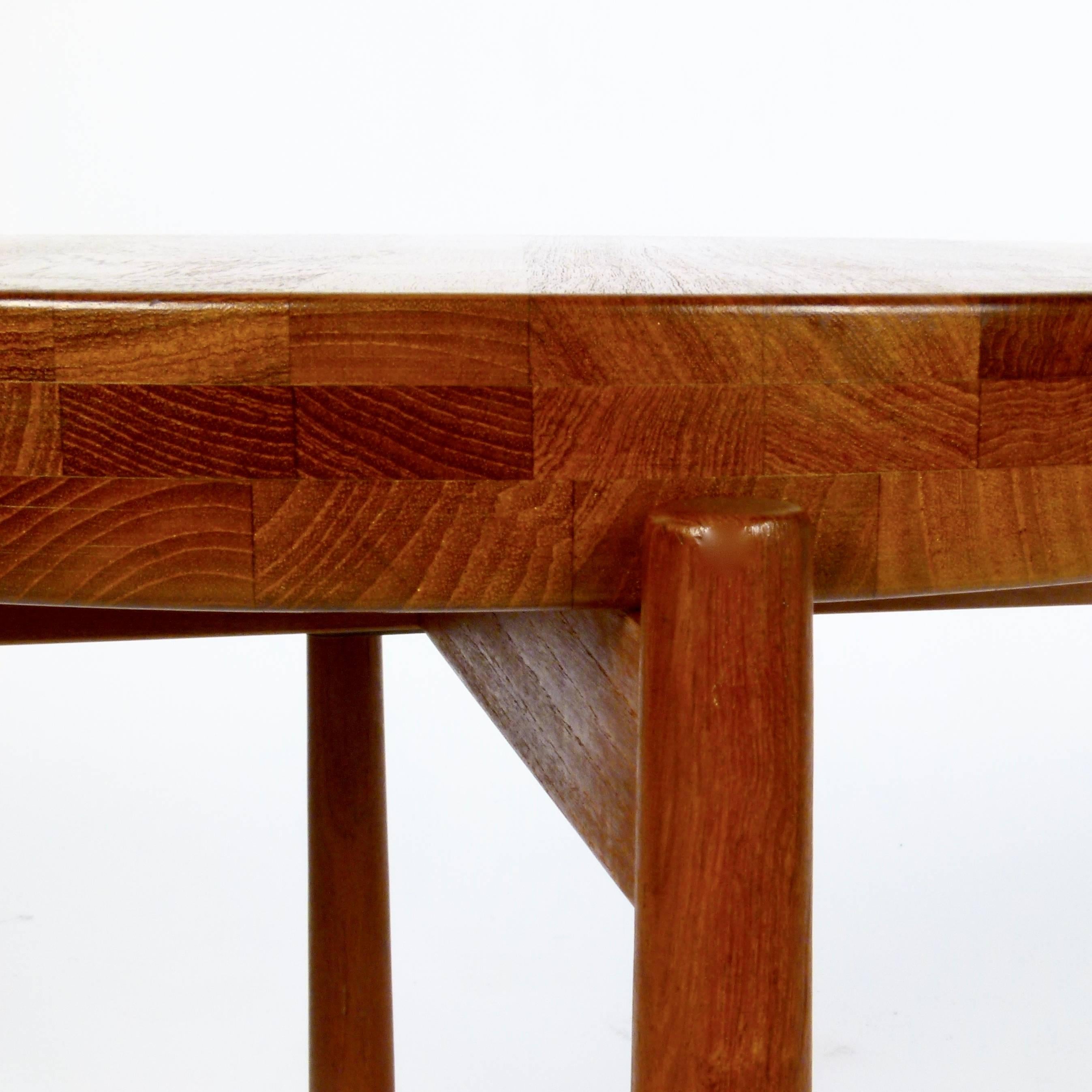 Unique teak flip-top side table designed by Jens Quistgaard for DUX, Sweden, circa 1965. Fully finished, solid teak top is concaved on one side and flat on the other.