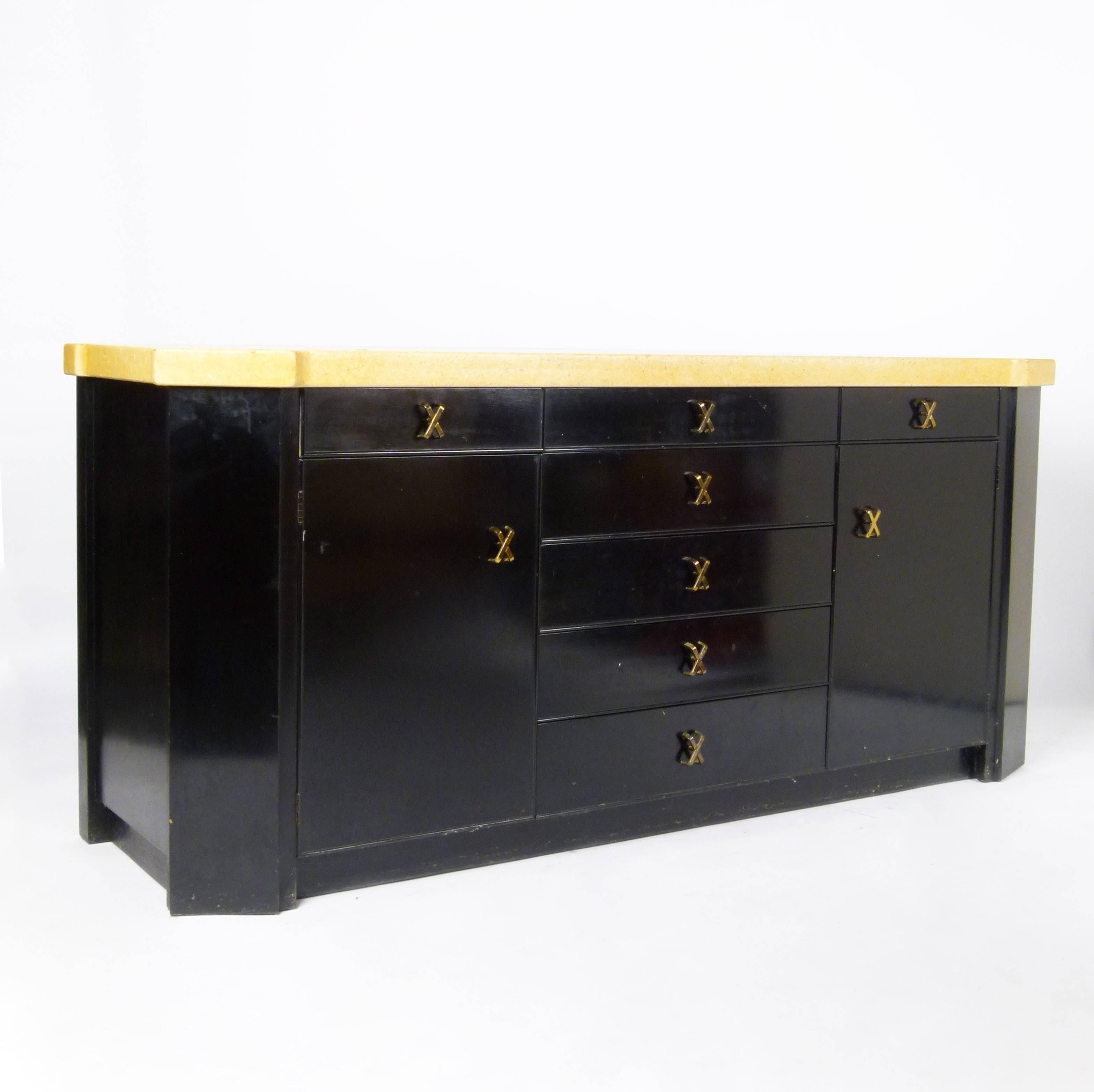 Classic Paul Frankl 1940s dining suite with cork tops over black lacquered bases and his Classic X brass pulls Johnson Furniture Company. A rare grouping including dining table with two leaves, sideboard with removable hutch (hutch includes sliding