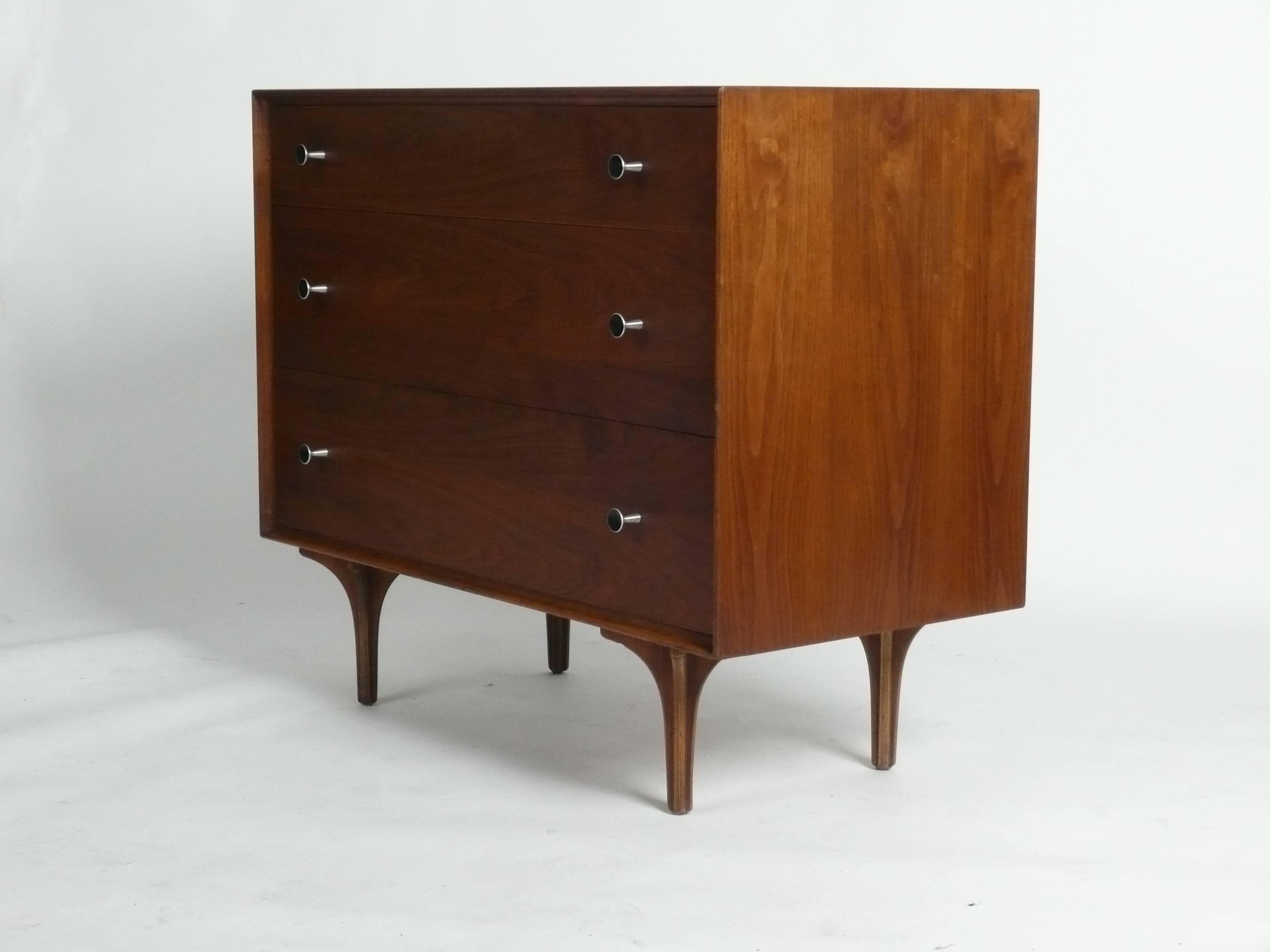 Early 1960s, oiled walnut, 3-drawer chest designed by Milo Baughman for Glenn of California.  Unique silver pulls and sculptural feet make this piece.
 