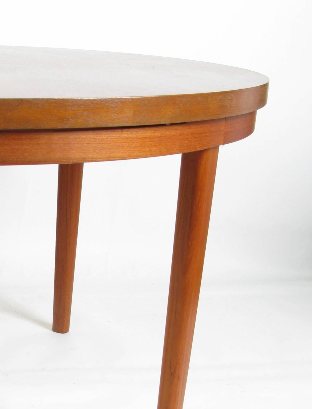 Rare 1960s teak dining table from Denmark by Dyrlund. It has 4 pull-out leaves that extend the size, but maintain its round shape. There are 3 things that make this table different than most others that you may have seen. They are usually pedestal