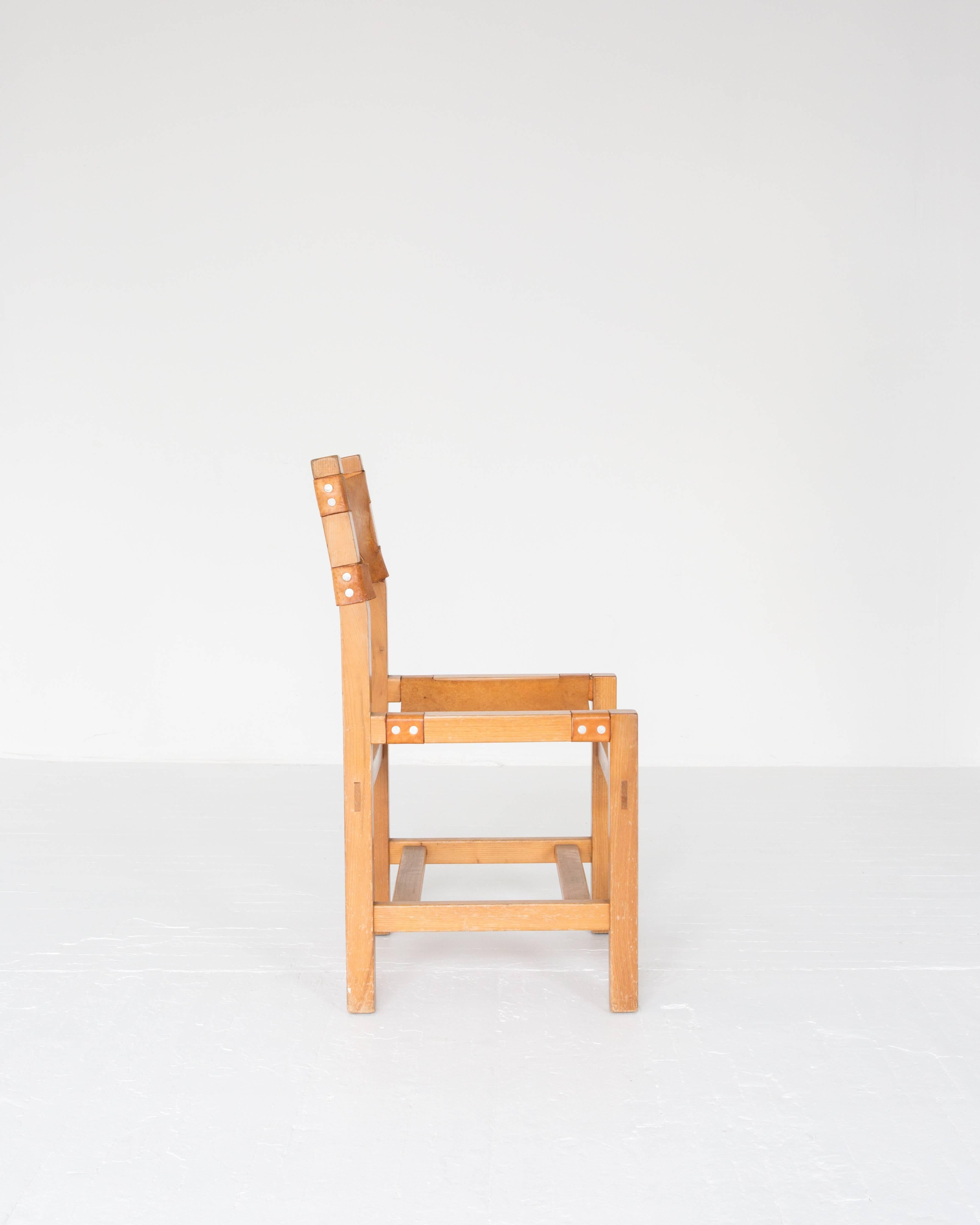 A simple French oak and leather side chair in the style of Chapo with a rich living patina on the leather.