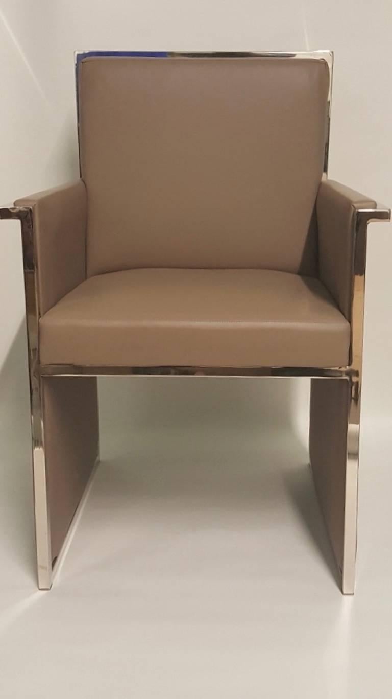 A rare pair of impeccable Milo Baughman chairs of polished chrome and smooth leatherette.