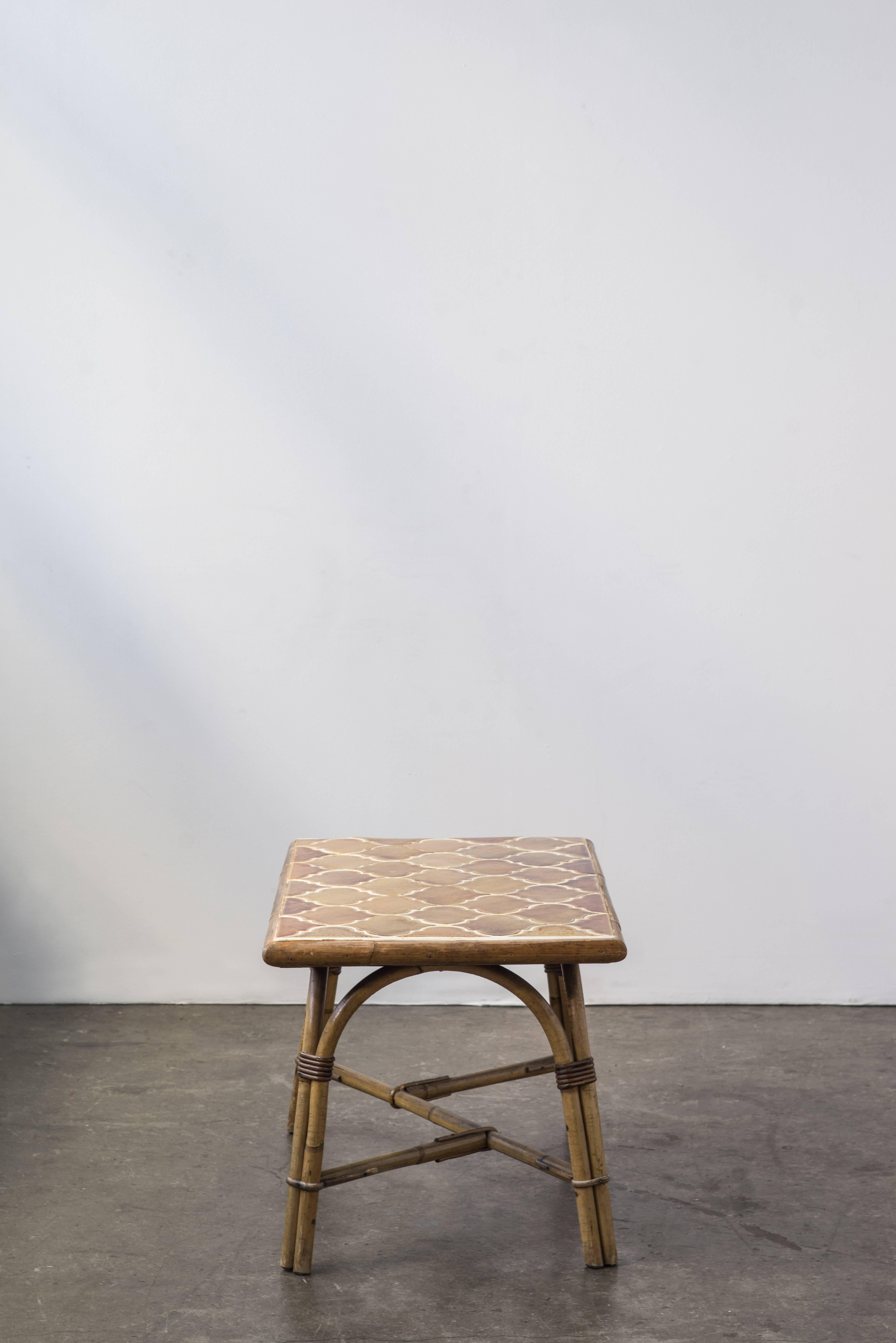 A rare ceramic mosaic table with a rattan frame by Adrien Audoux and Frida Minet.