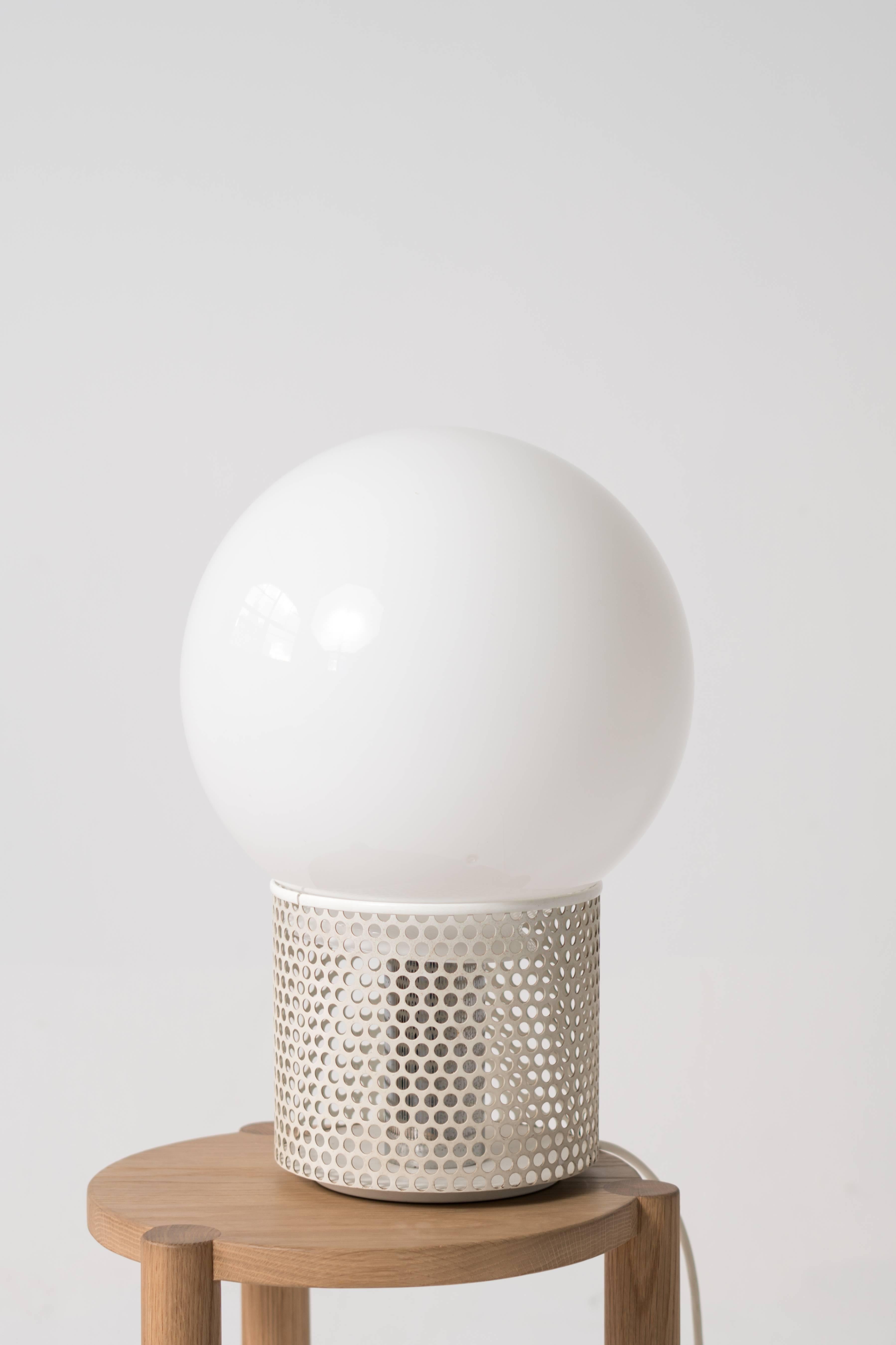 A very large orb lamp by Michel Boyer with a white lacquered perforated metal base. 

The light has been rewired with a US plug and is fully functional with a new LED light bulb.