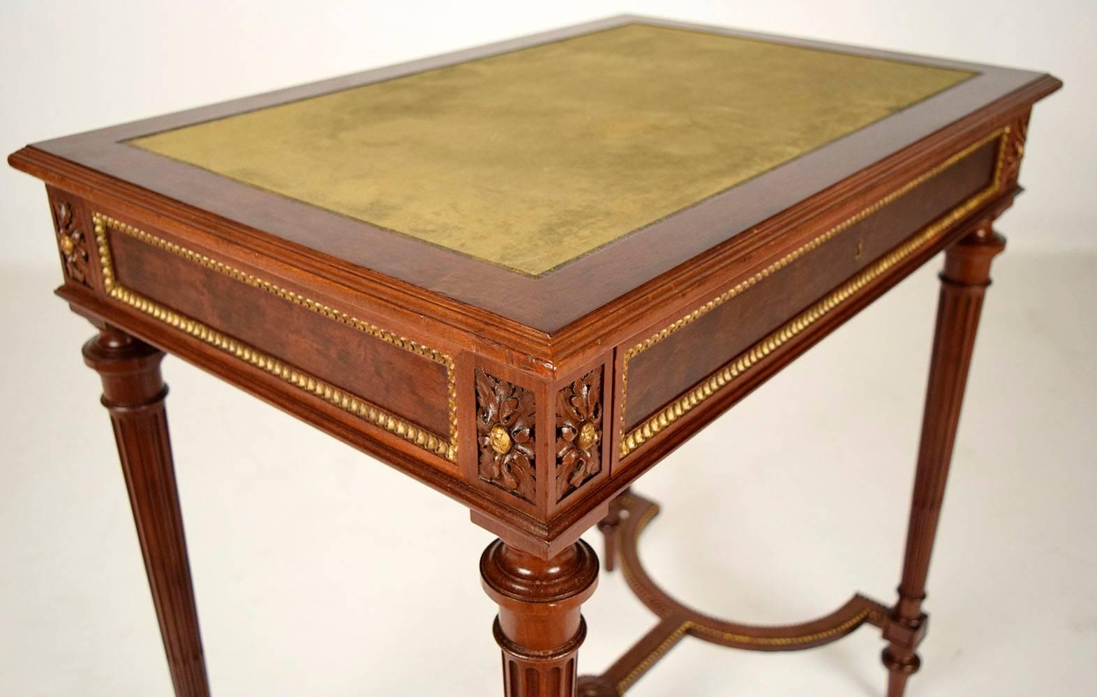 This stunning 19th century Paul Sormani writing desk is made from mahogany wood in its original mahogany stain color finish. The desk top features the original embossed leather writing area in a lovely shade of green. Around the edges of the desk