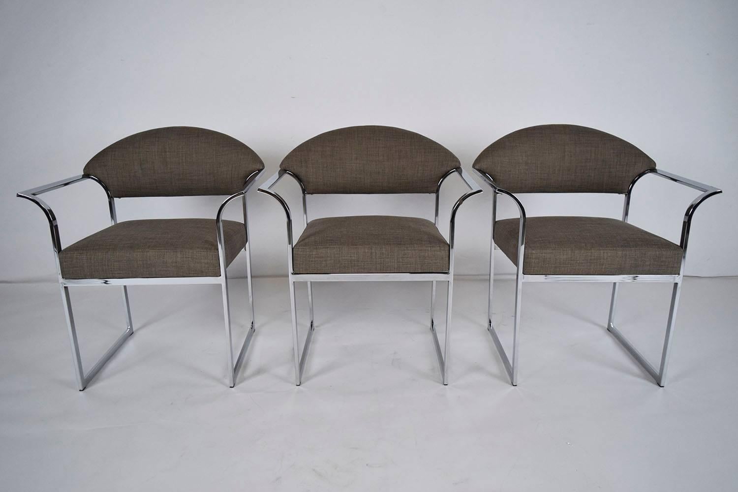 This 1960s vintage set of six Mid-Century Modern style dining chairs feature reflective chrome frames. The simple frame is accented by the winged arm rests that make this set of chairs one of a kind. The chair backs and seats have recently been