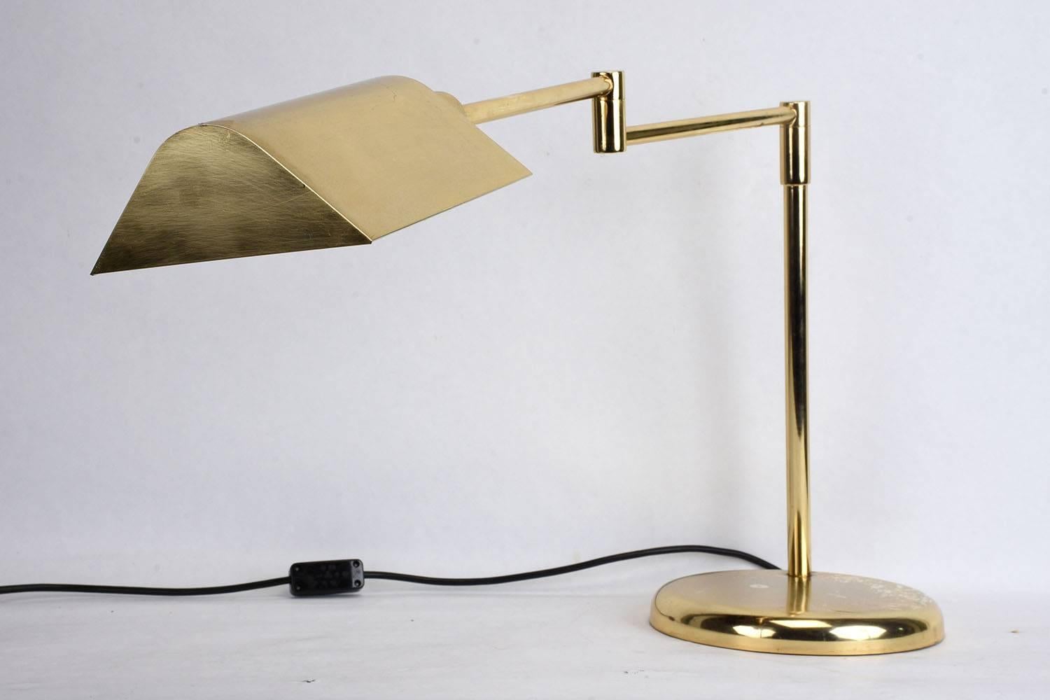 This 1960s vintage Modern-style table or desk lamp is made by Koch and Lowy. The brass-plated steel lamp features an adjustable arm for user convenience, the lamp is wired to US standards and is in working condition. This desk lamp is sturdy,
