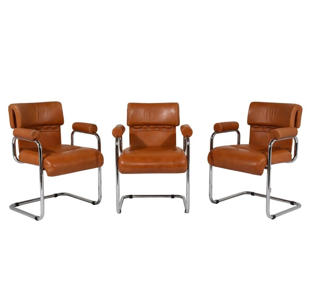 This set of six Italian Mid-Century Modern-style dining chairs are designed by Mariani and feature a chromed steel frame. The comfortable chairs are upholstered in the original rust orange color leather with stitched details. The set of six dining