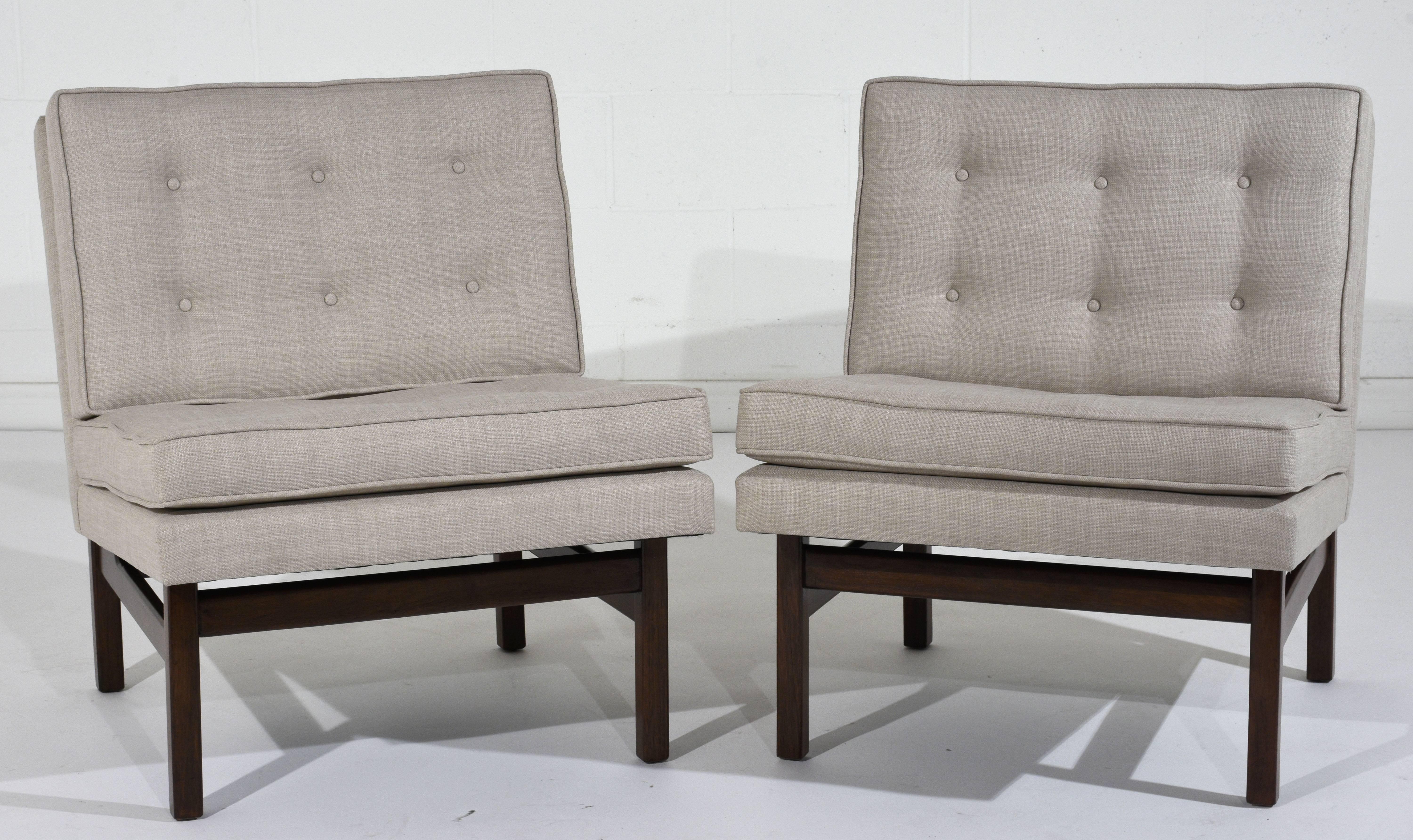 This pair of 1960s Mid-Century Modern-style Slipper Lounge Chairs are made out of teak wood with a rich walnut color stain and a newly lacquered finish. These slipper chairs have been professionally upholstered in a new soft gray color fabric with