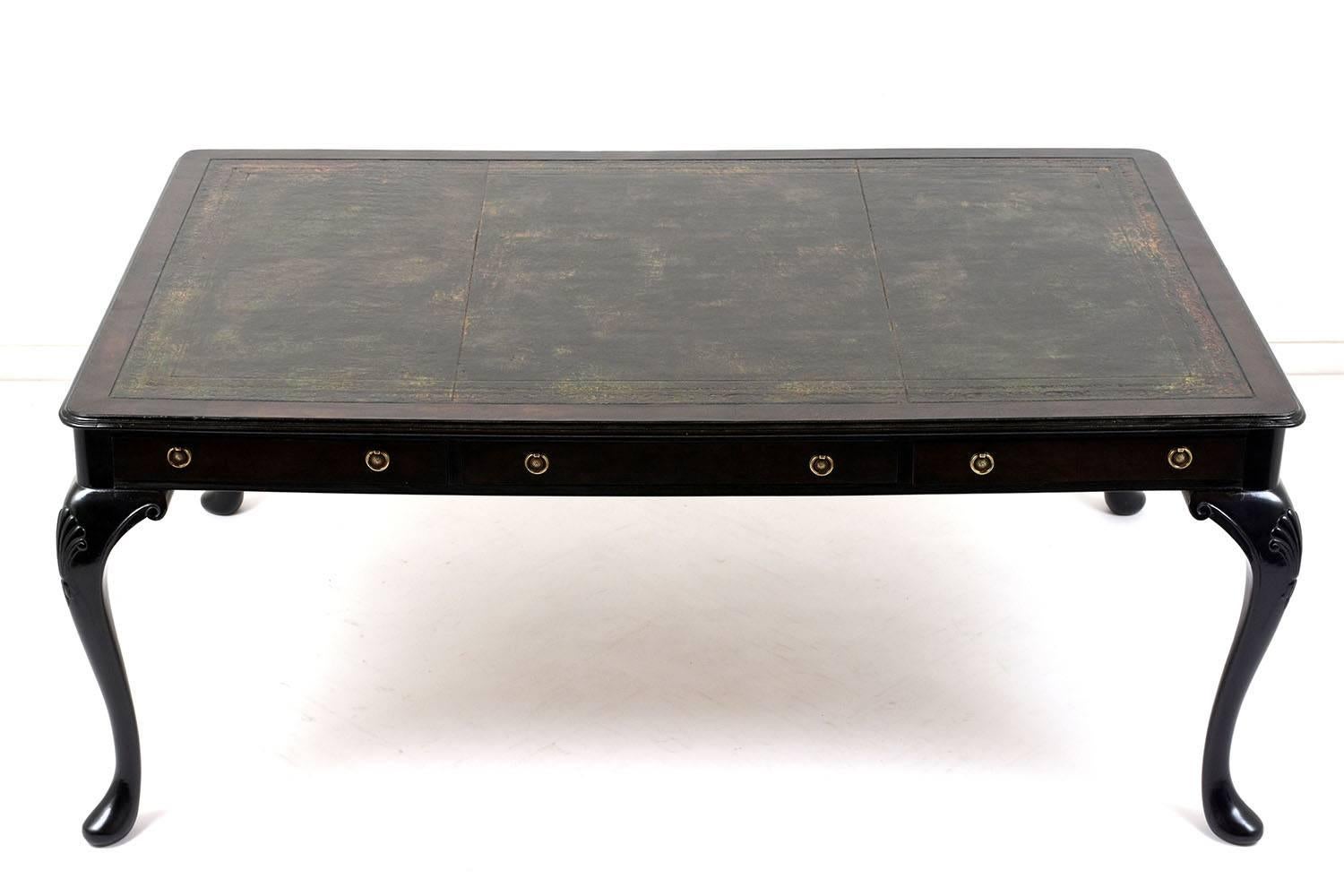 This elegant 1910s English partners desk is made of solid mahogany wood ebonized in a rich black color with a lacquered finish. The desk top features a three section leather embossed top with beautiful patina details. The body of the desk features
