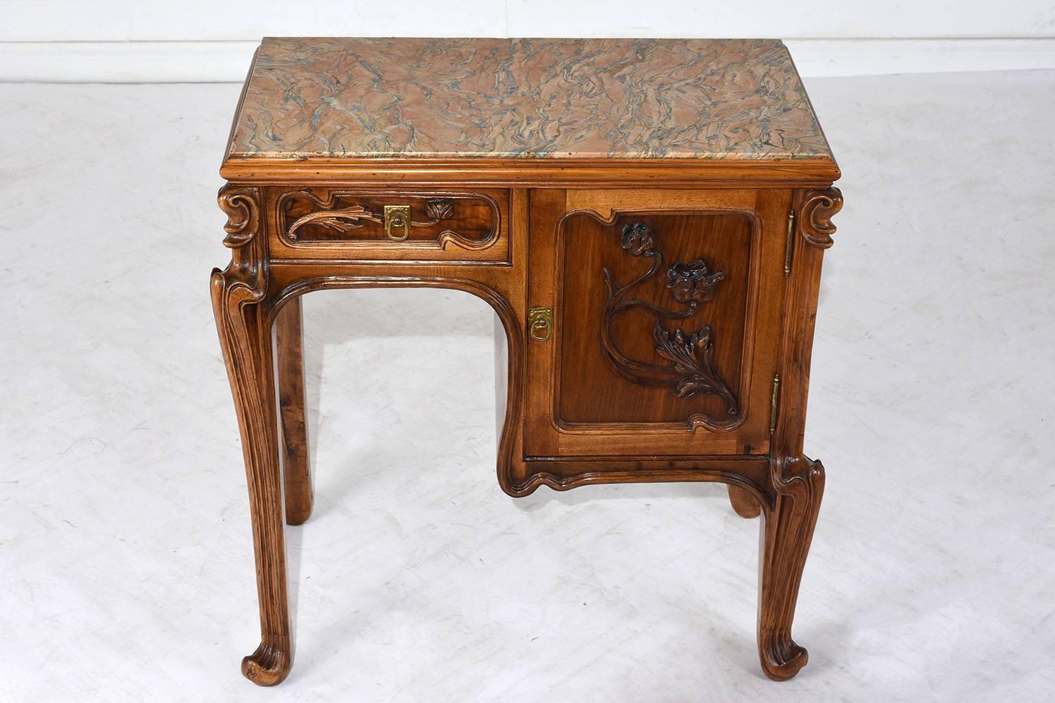 This rare, 1900s Art Nouveau nightstand or side table is made is made in the manner of Louis Majorelle. The nightstand is made of walnut wood in its original walnut color stain and has recently been polished and waxed. This nightstand is
