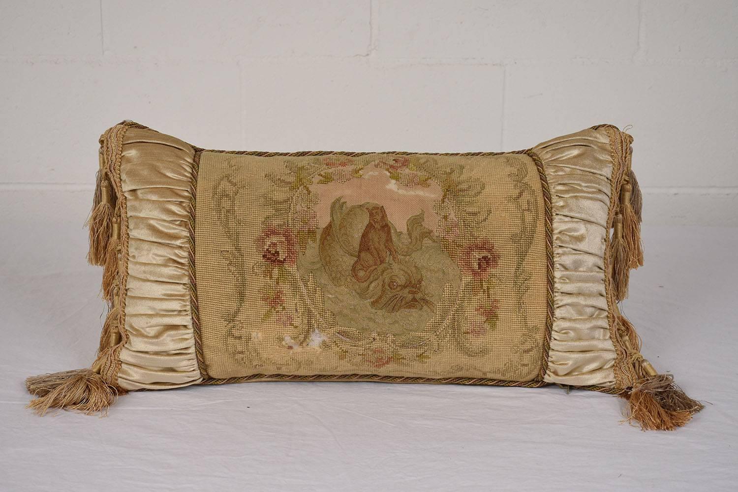 This pair of throw pillows features late 19th century Aubusson tapestry panels. The tapestries depict pastoral scenes of real and mythical animals surrounded by decorative floral, garland, and acanthus leaf details. The tapestry is bordered by a