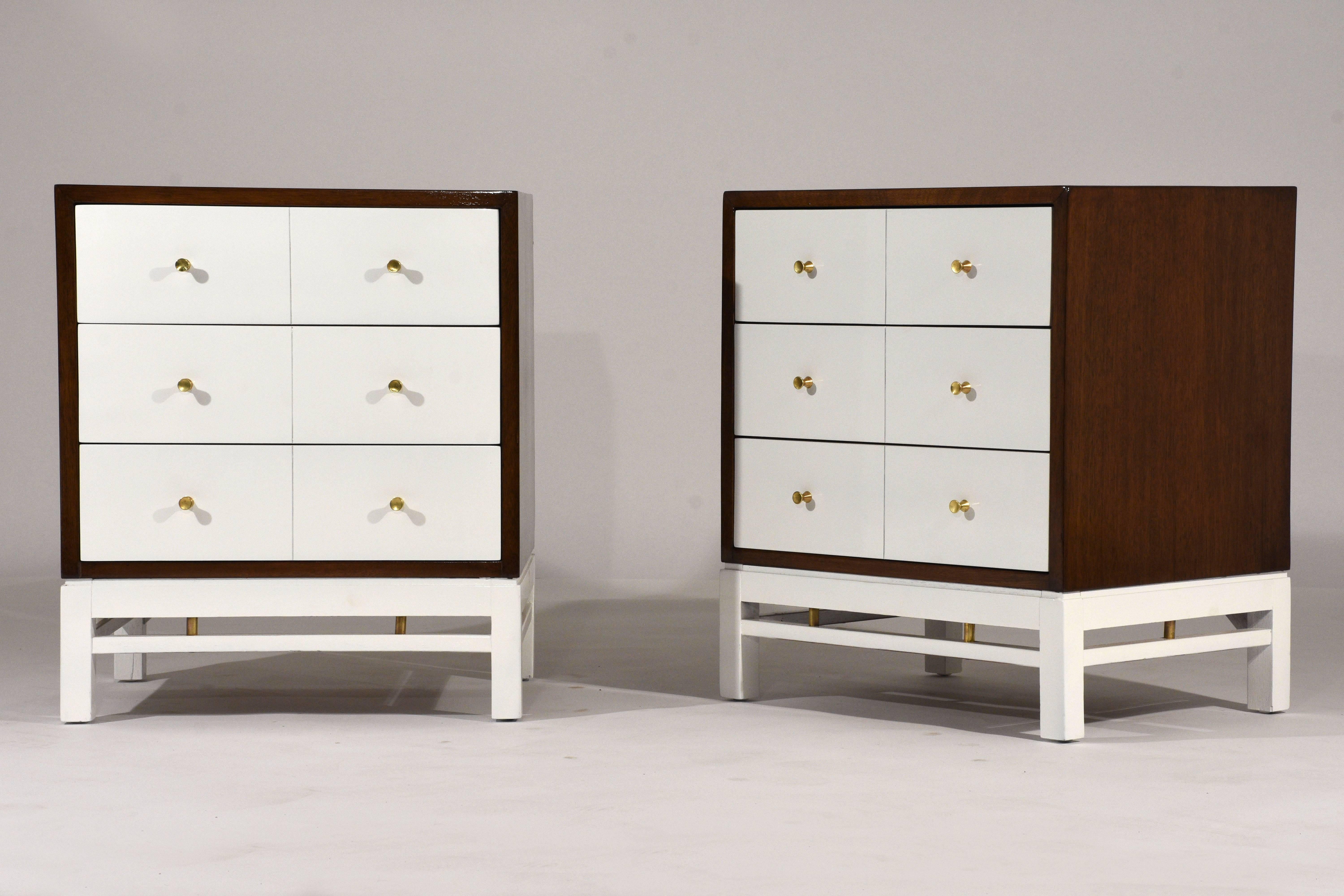 This pair of 1950s Mid-Century Modern style side tables or nightstands are designed by Paul McCobb. The outside of the night stands are finished in a rich walnut color stain and the facade of the drawers and the base are finished in an off-white