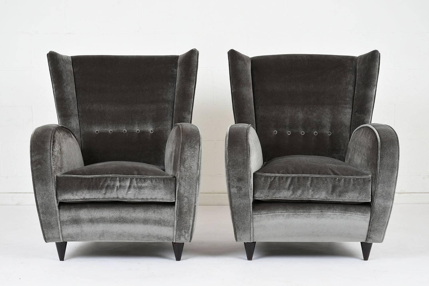 This pair of 1950s Modern style lounge chairs are designed by Paolo Buffa. The chairs have been completely restored with new upholstery in a dark grey mohair velvet fabric. The chairs have single piping trim details and tufted details on the seat