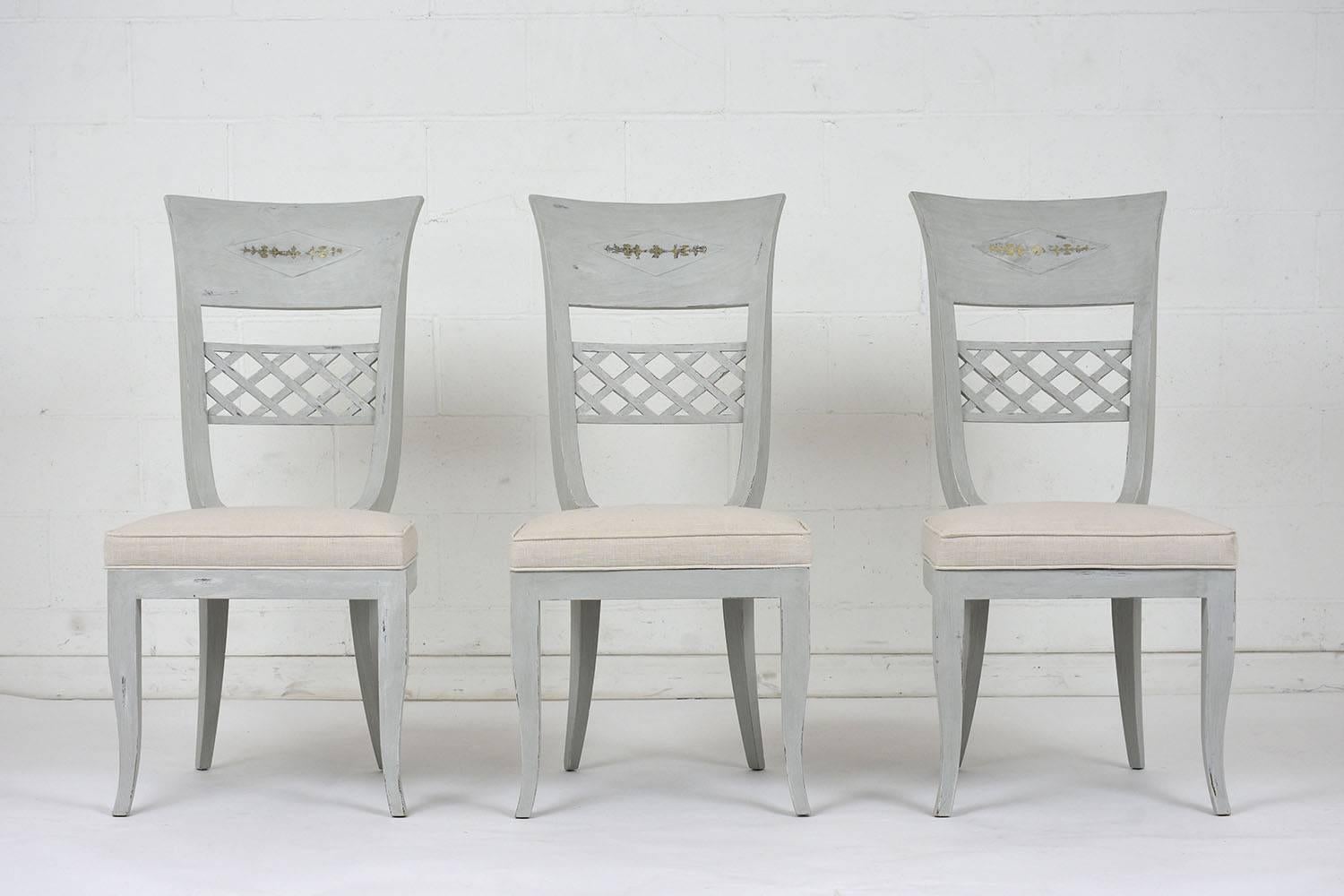 This set of six 1970's Hollywood Regency-style Dining Chairs has solid wood frames that have been newly painted in a soft gray & off-white color combination with a distressed finish and have been newly restored. The chairs feature a high back