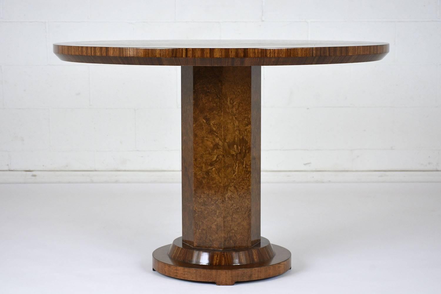 This 1960s French Art Deco-style Lacquered round center table is covered in walnut wood veneers stained a rich walnut color with a lacquered finish. The pedestal base has a faceted design with a round base. This center table is sturdy, stunning, and