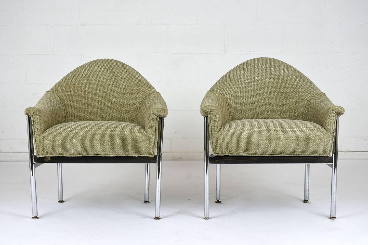 This pair of 1960s Mid-Century Modern-style lounge chairs have been completely restored with new upholstery in a sage green fabric with piping trim details. The chairs feature a sleek chrome base that compliments the comfortable seats. This pair of