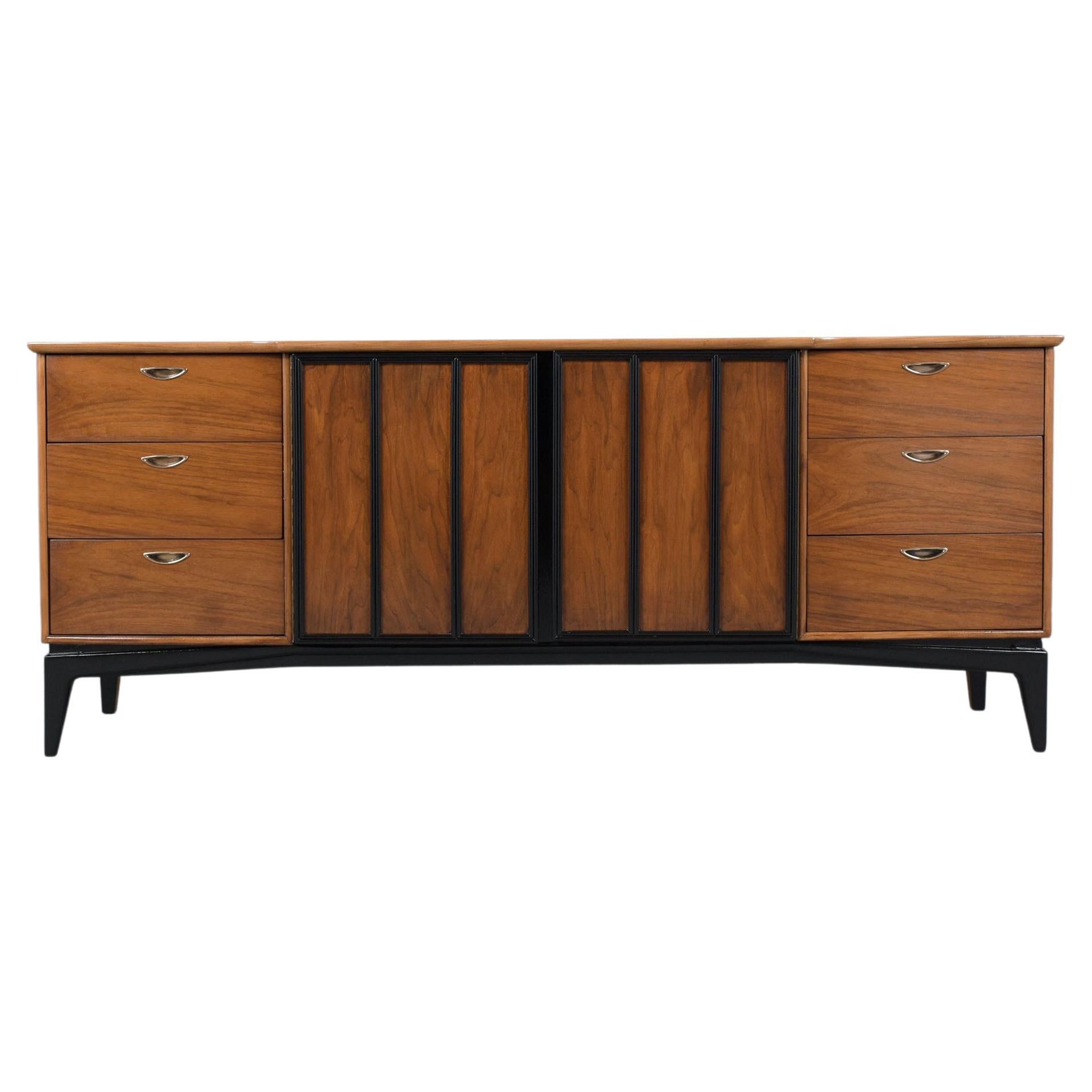 Discover the allure of our Mid-Century Modern Walnut Credenza, a stunning piece meticulously restored by our expert craftsmen. Crafted from high-quality walnut wood, this credenza has been fully restored, stripped, and re-stained in a walnut and
