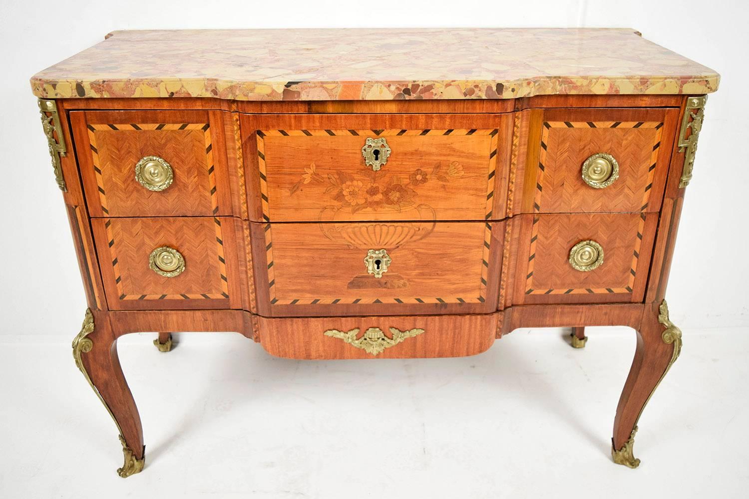 This is an unique circa 1880's French Louis XVI-style chest of drawers. It features the original multicolored beveled marble-top. The solid wood desk is covered with elegant marquetry and inlaid designs. The two front drawers have inlaid design on